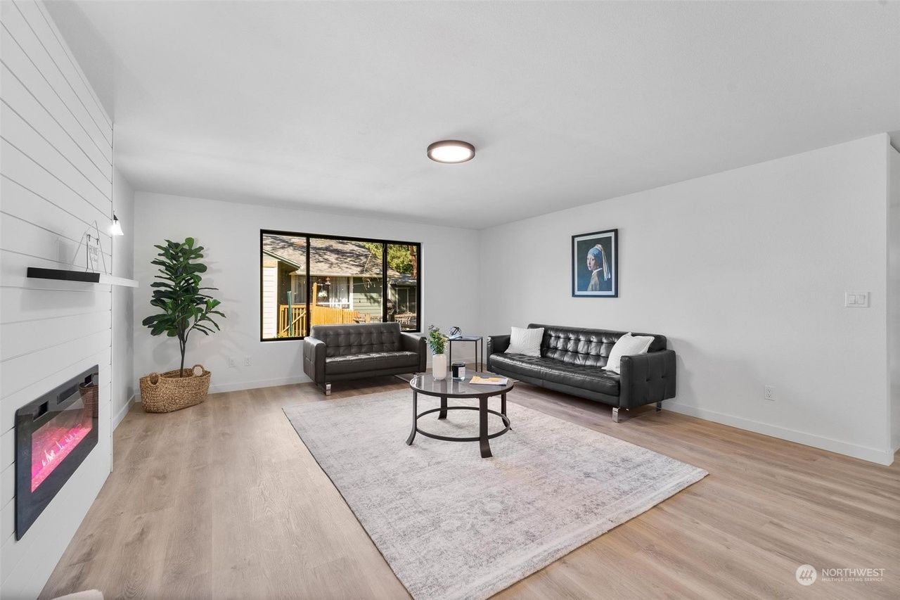 A living room with two couches , a coffee table , and a fireplace.