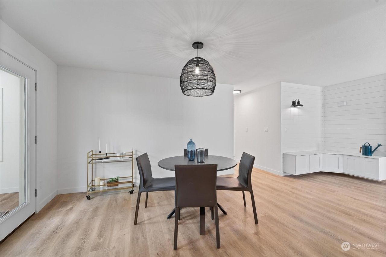 A dining room with a table and chairs in it.