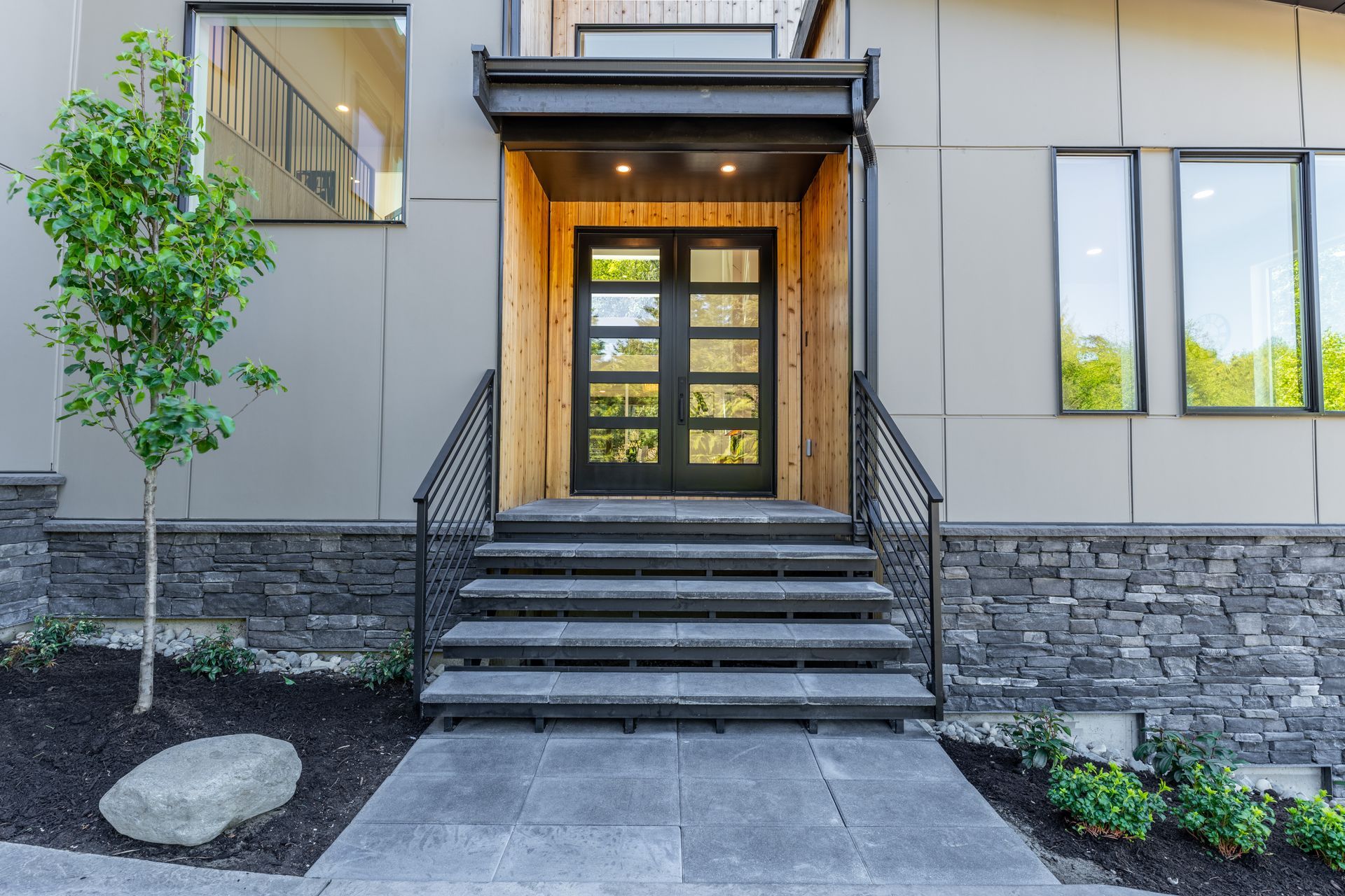 The front door of a house with stairs leading up to it.