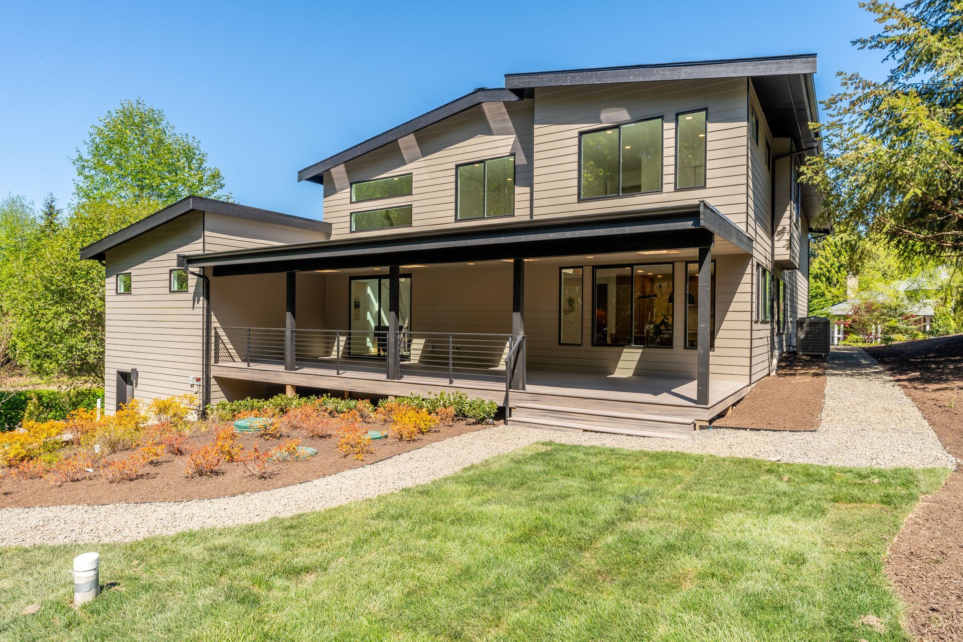 A large house with a large porch and a lot of windows.