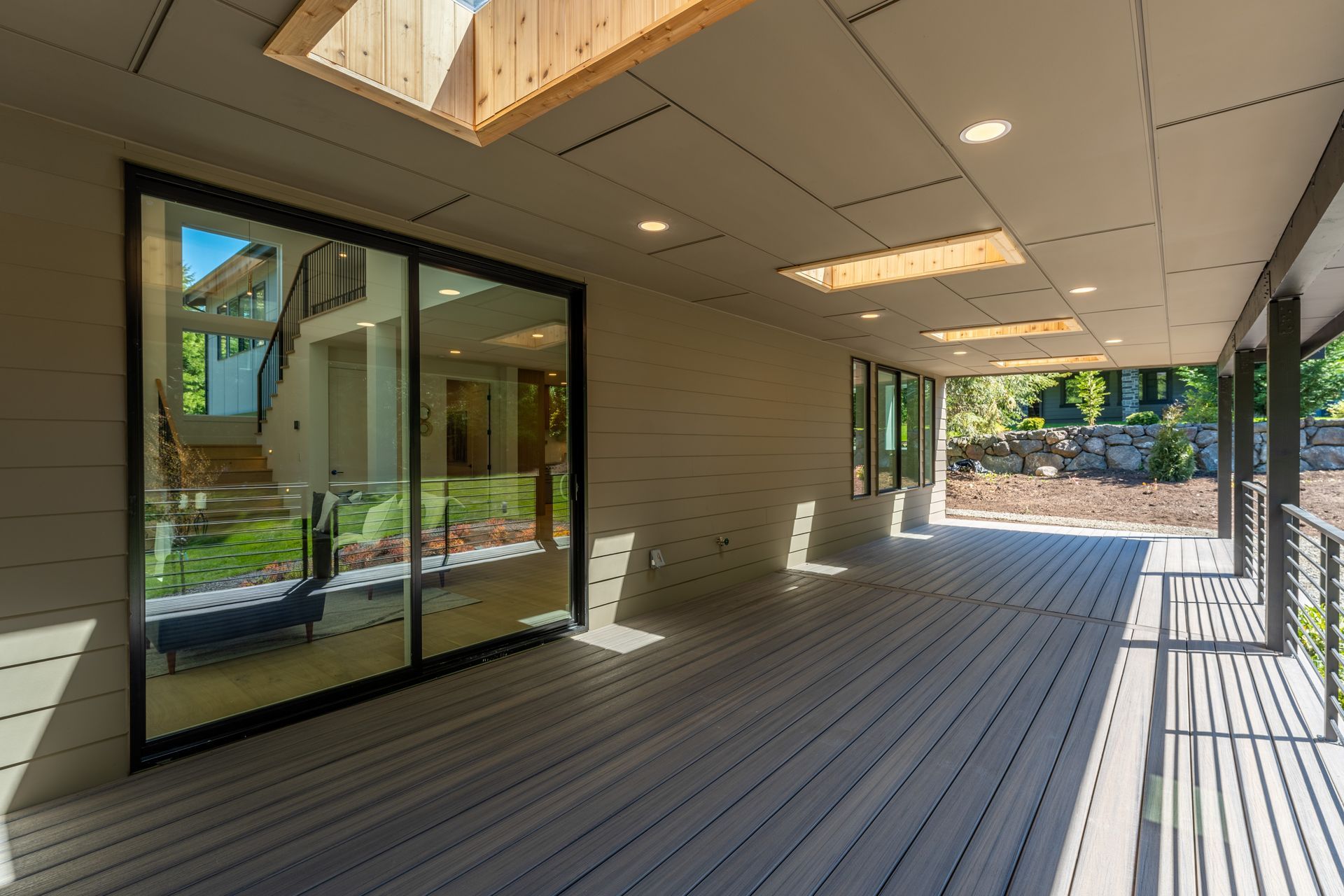 A large patio with sliding glass doors and a skylight.