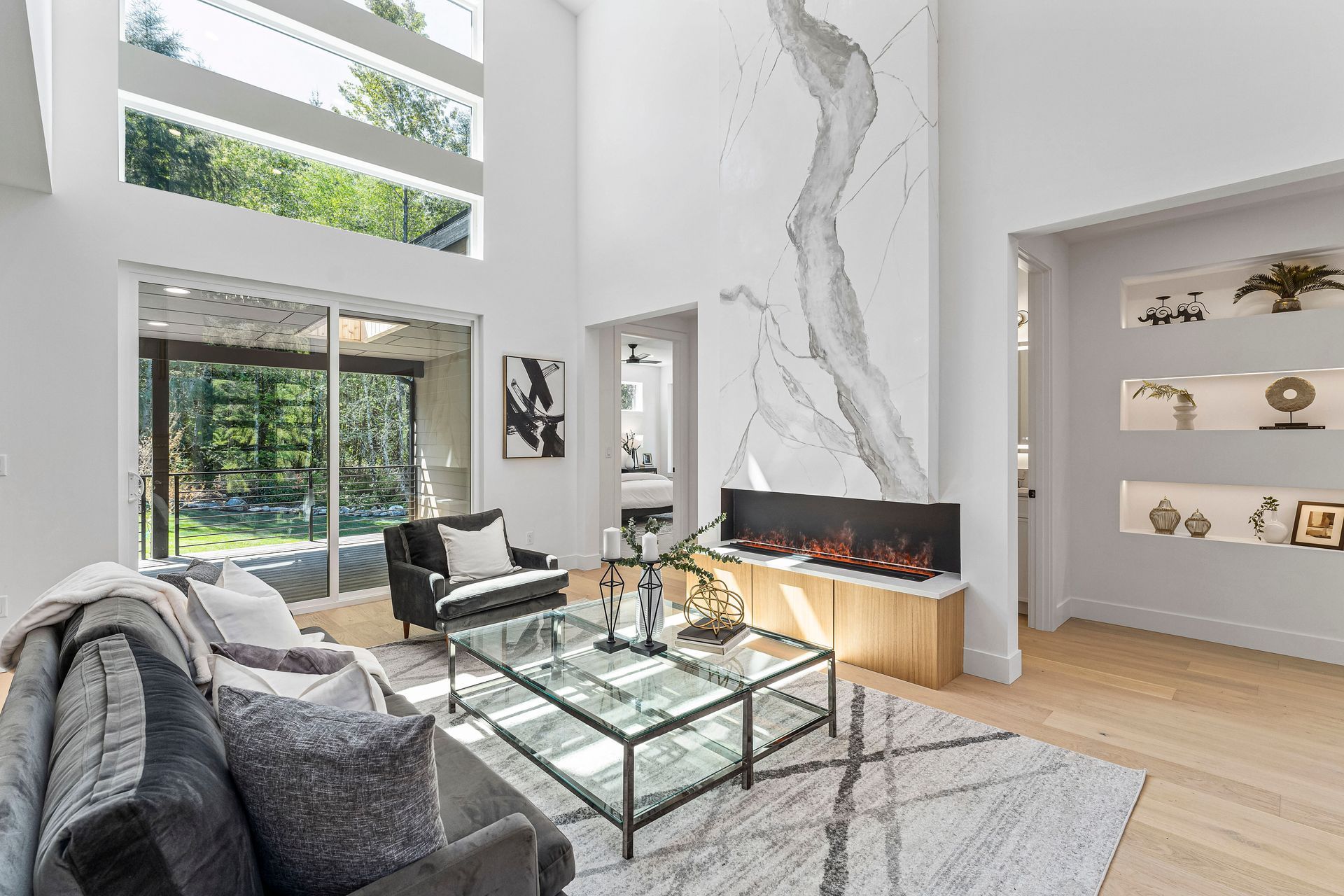 A living room with a couch , chair , coffee table and fireplace.