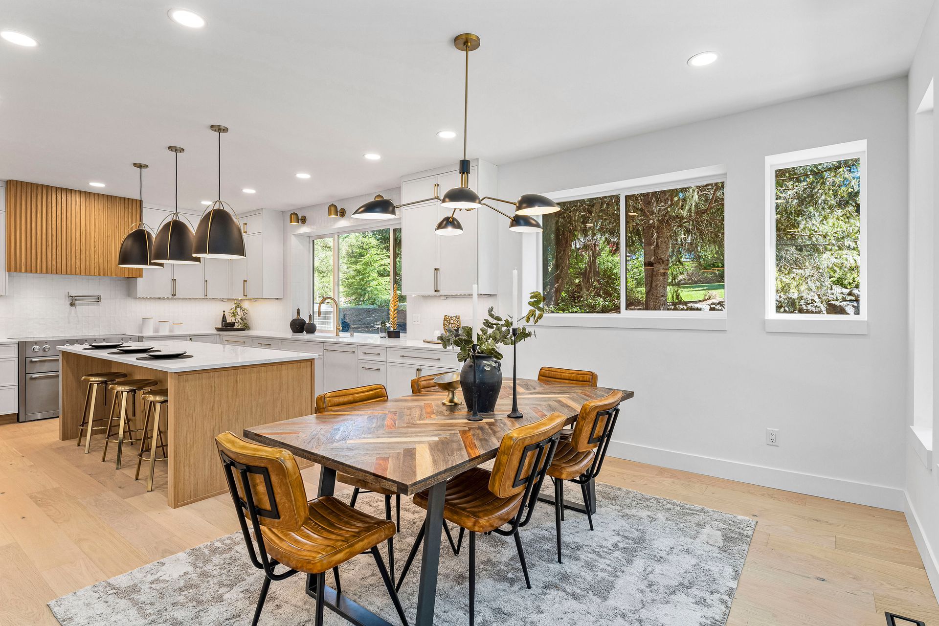 A kitchen and dining room in a house with a table and chairs.