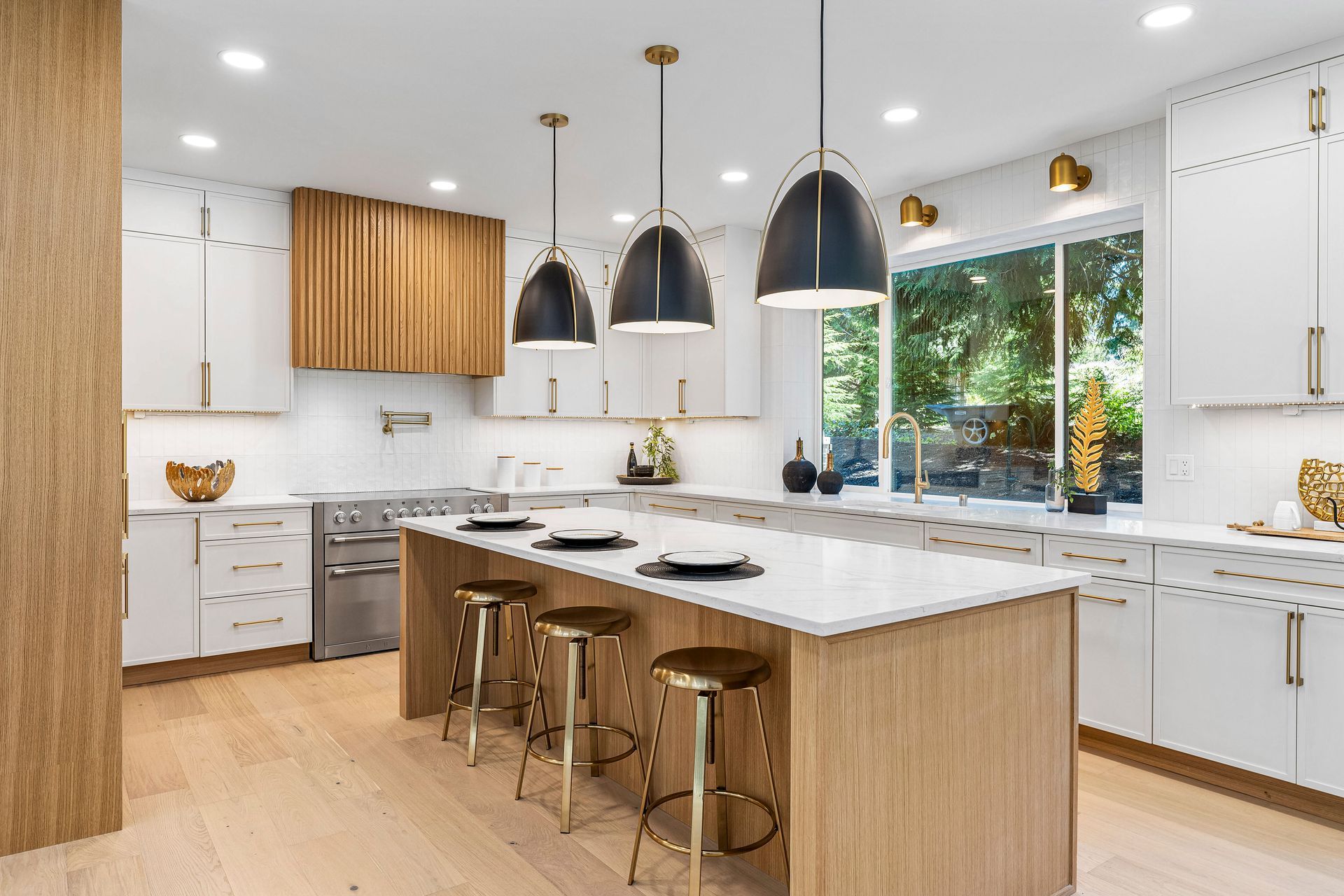 A kitchen with white cabinets , wooden cabinets , and a large island.