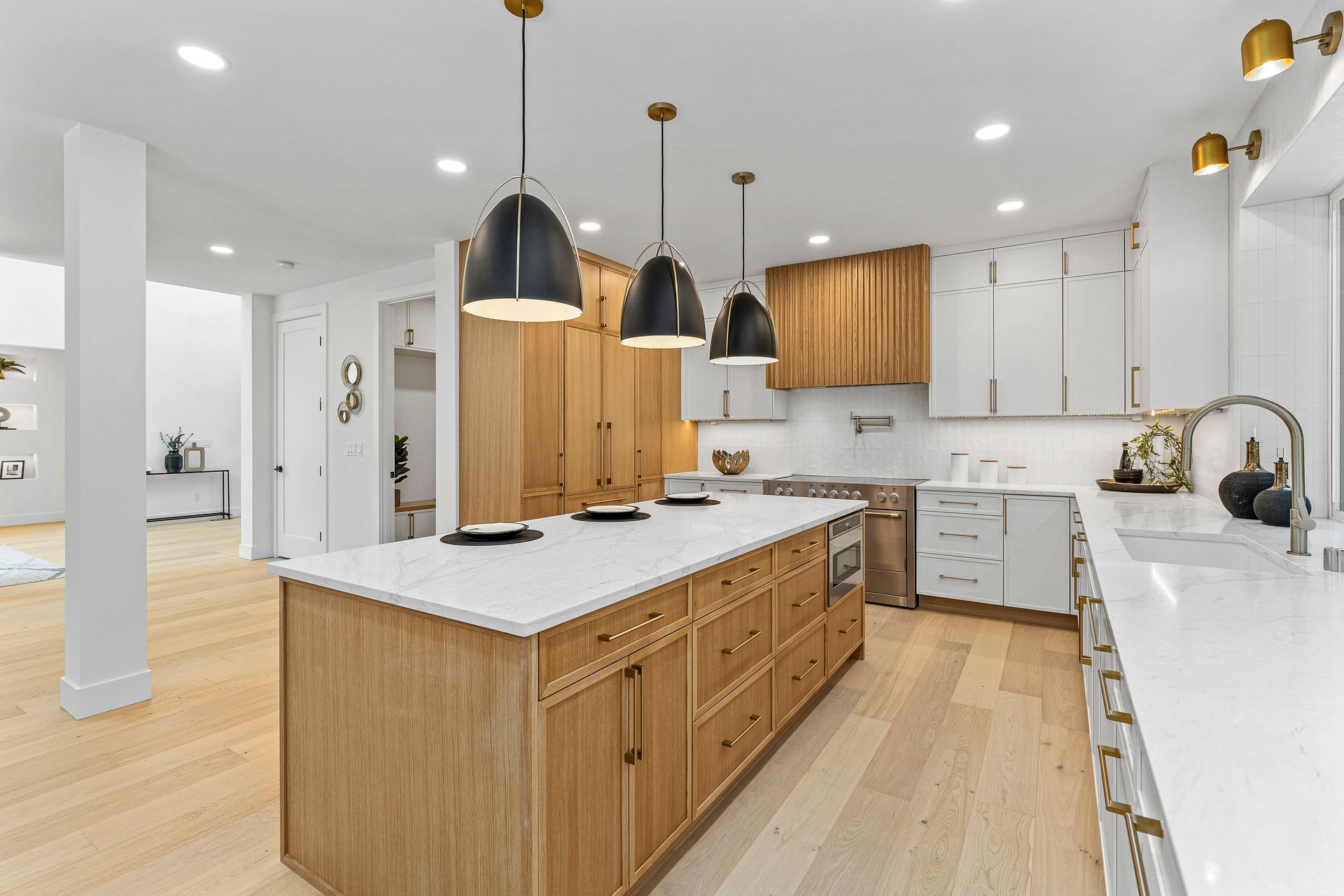 A kitchen with wooden cabinets , white counter tops , and a large island.