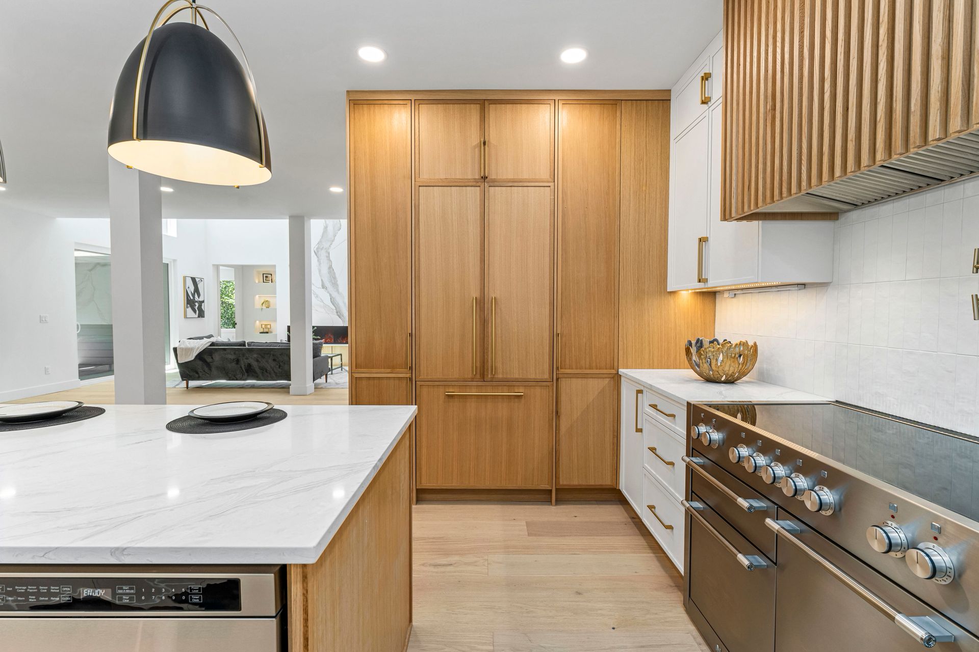 A kitchen with stainless steel appliances and wooden cabinets
