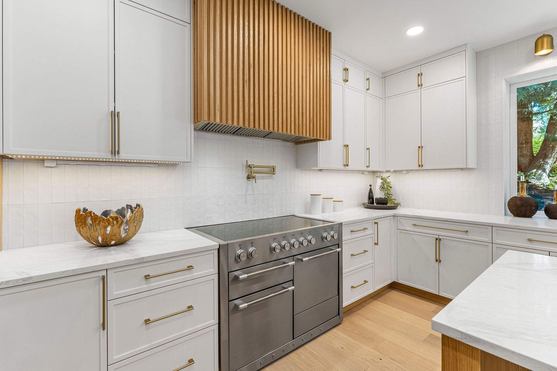 A kitchen with white cabinets and stainless steel appliances.