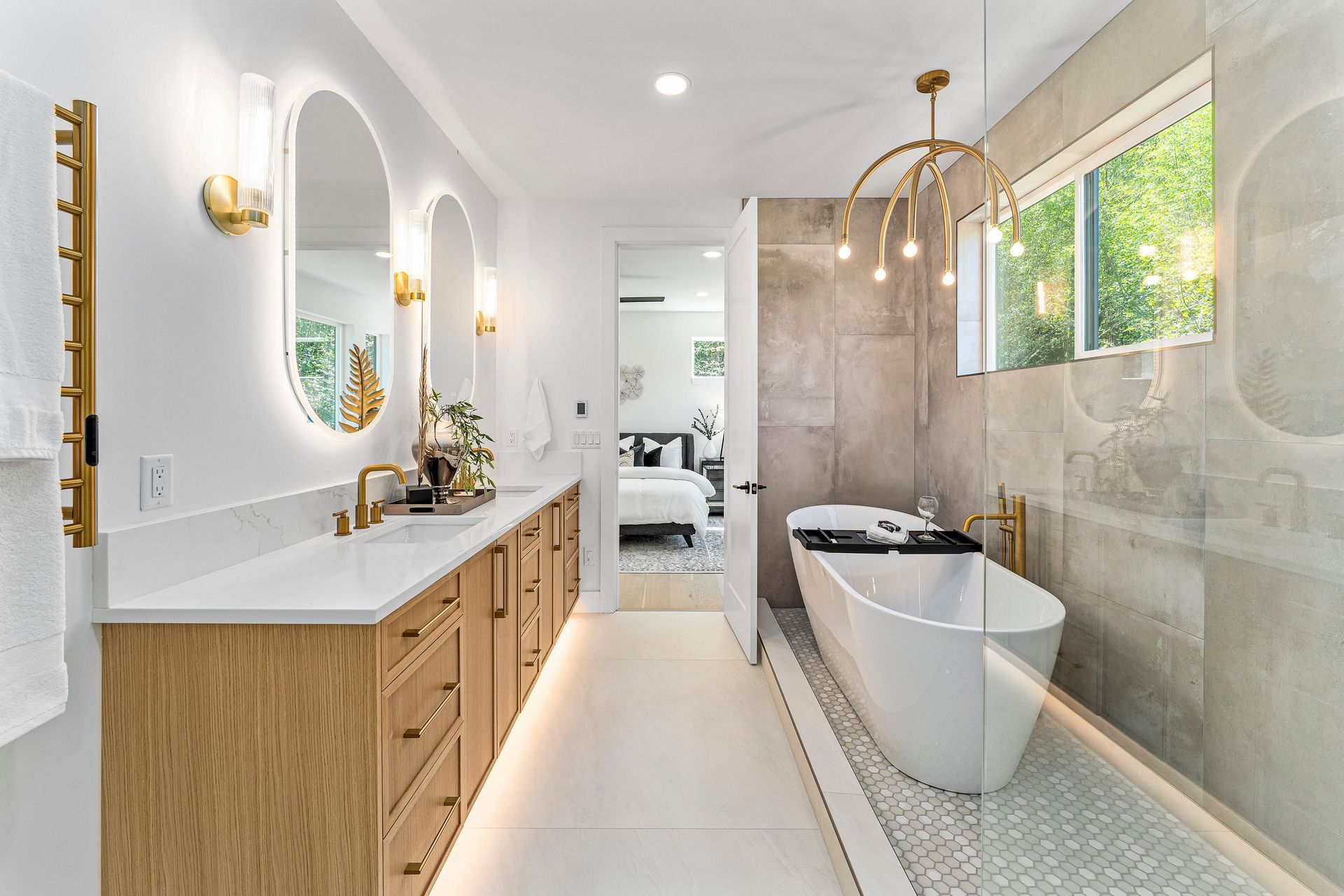 A bathroom with a bathtub , sinks , mirrors and a walk in shower.