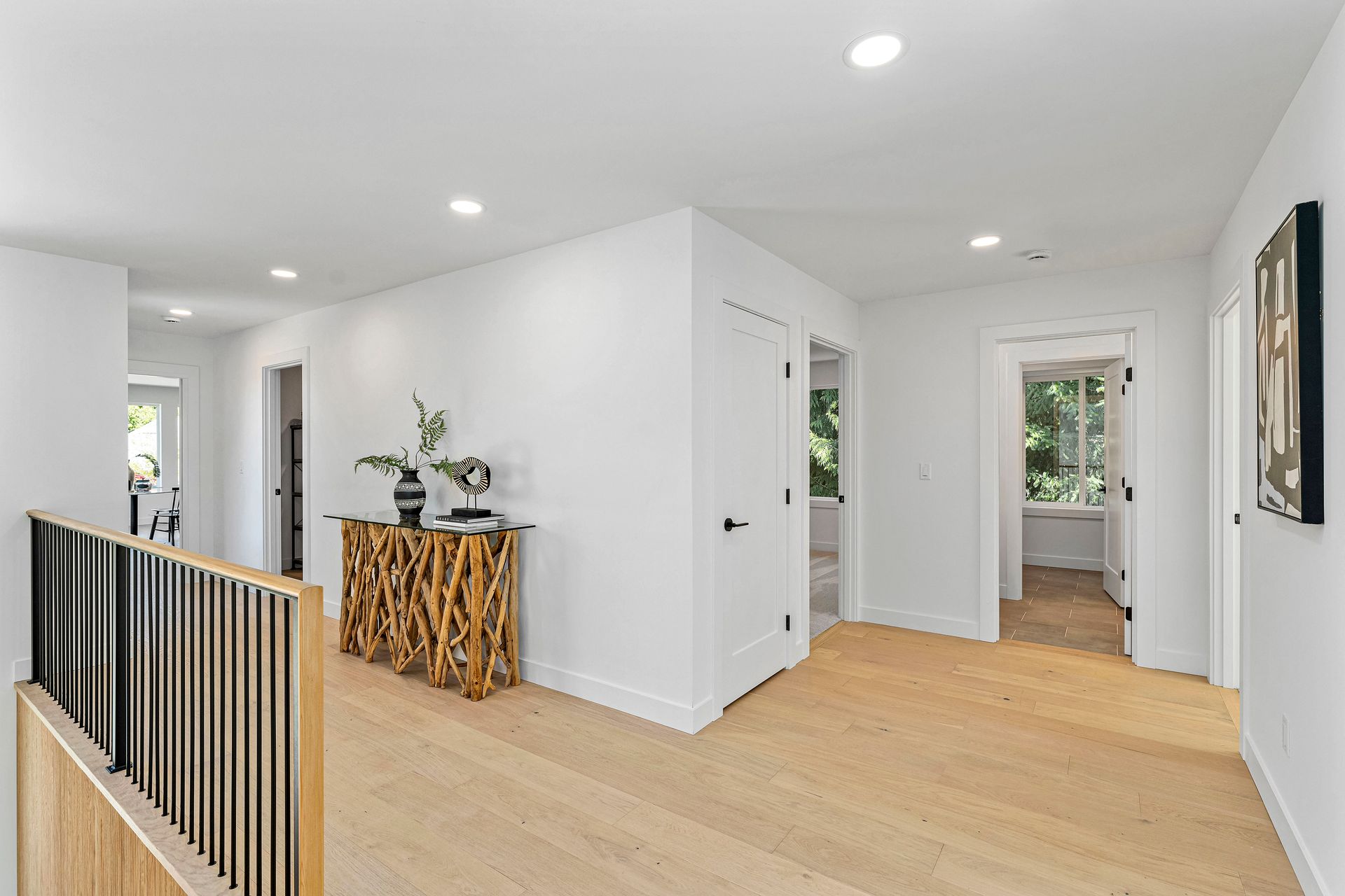 There is a wooden table in the middle of the hallway.