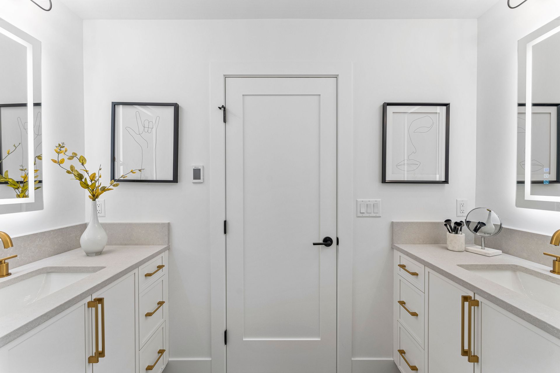 A bathroom with two sinks and two mirrors.