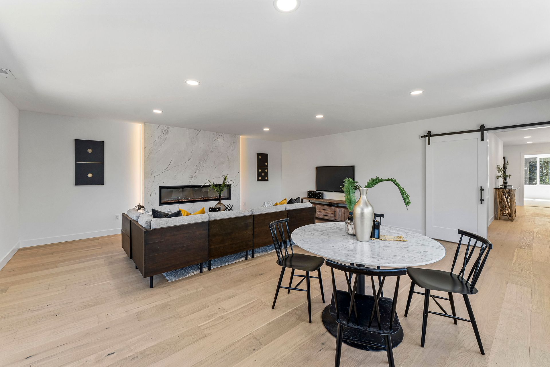 A living room with a table and chairs in it.