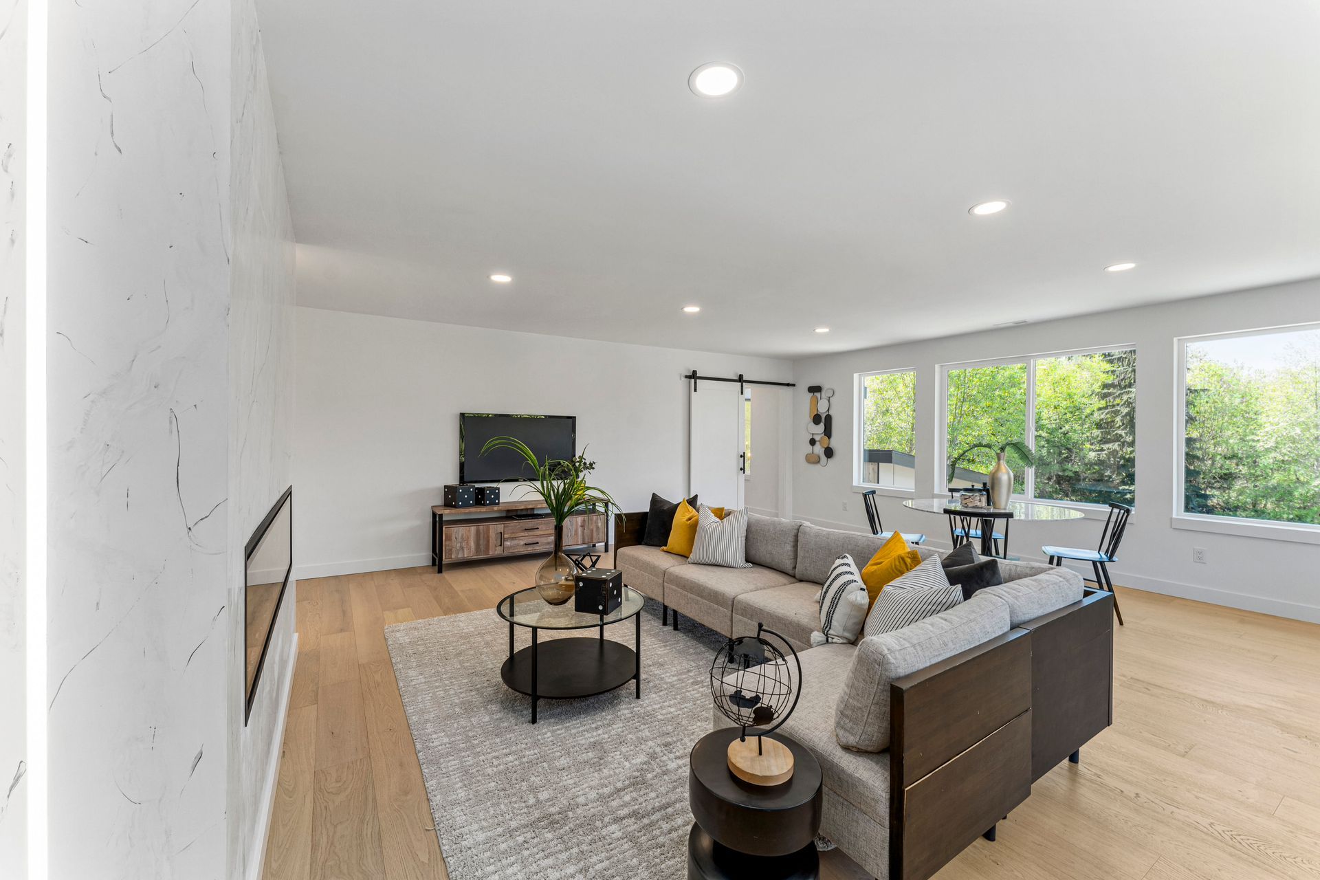 A living room with a couch , coffee table , and television.