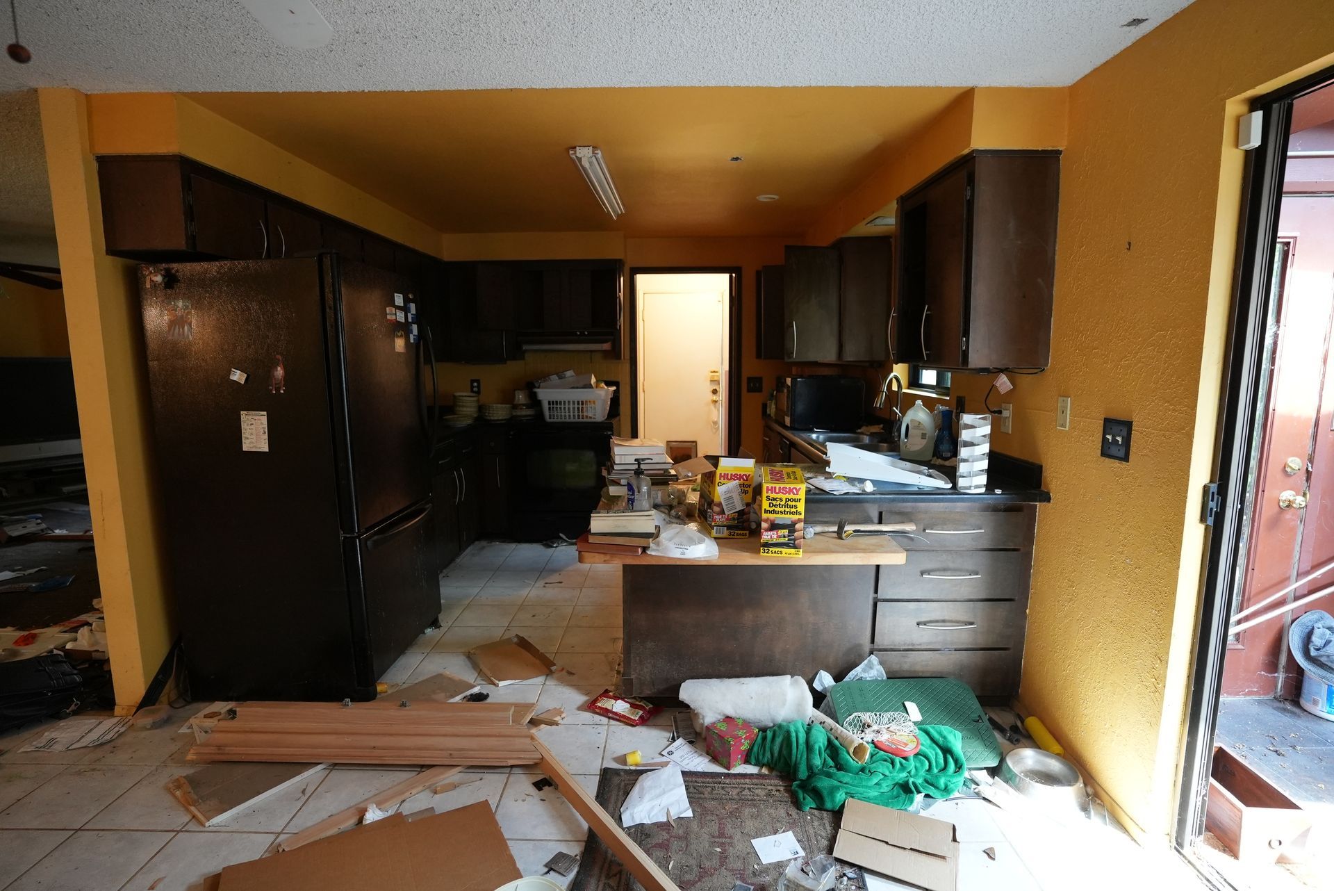 A messy kitchen with a yellow box on the counter that says k-mart