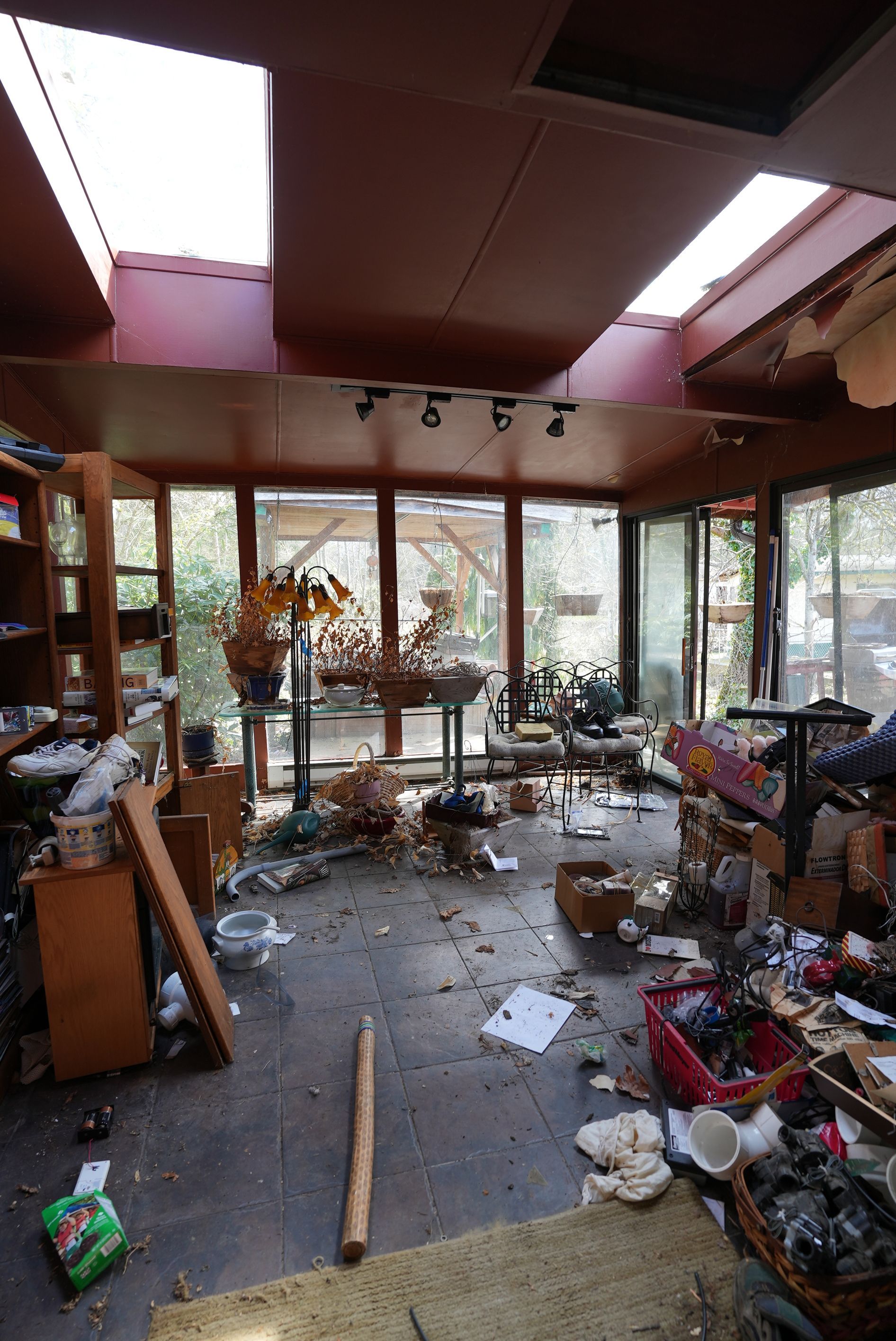 A very messy room with a lot of junk on the floor.