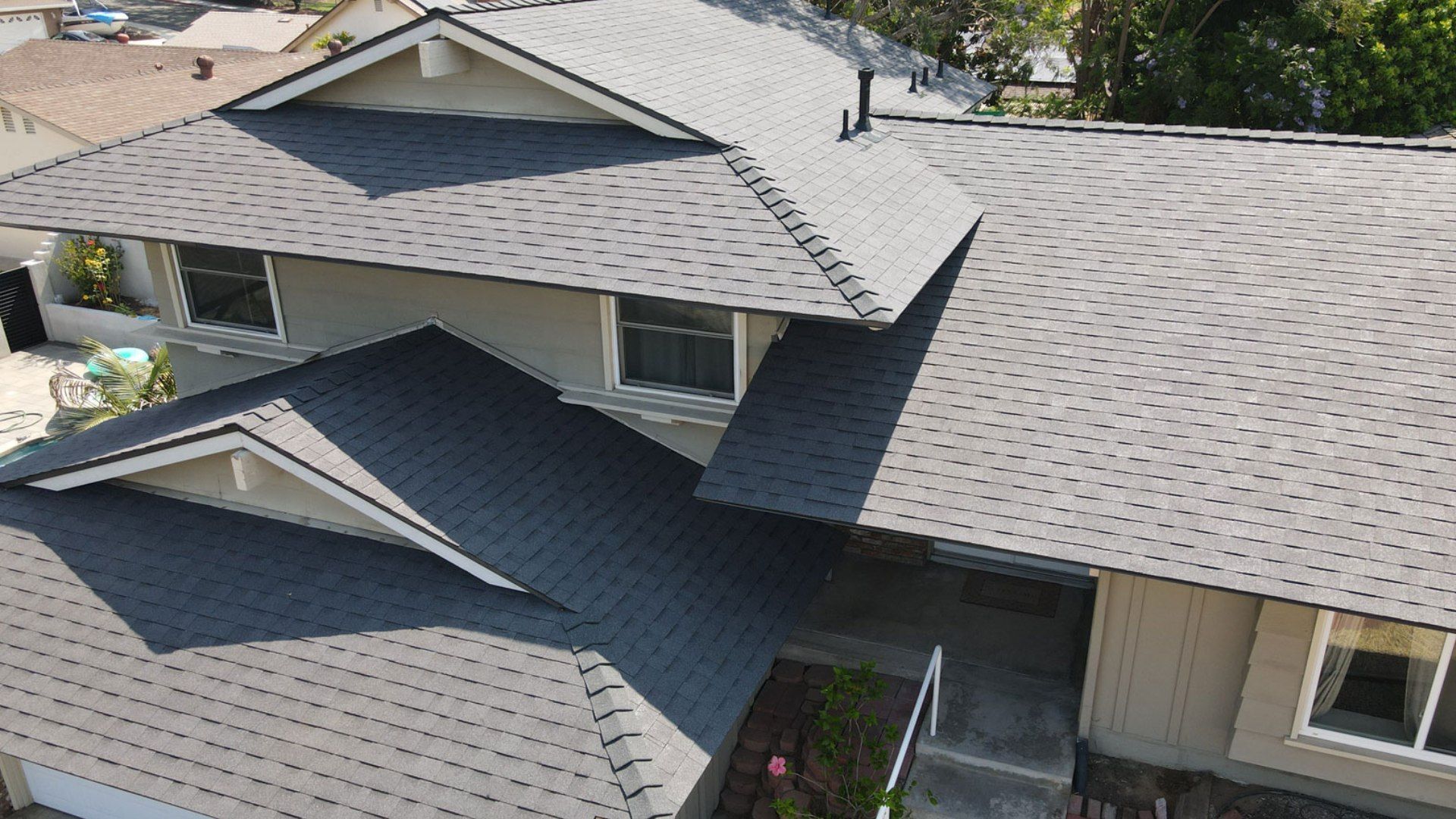 An aerial view of a house with a new roof.