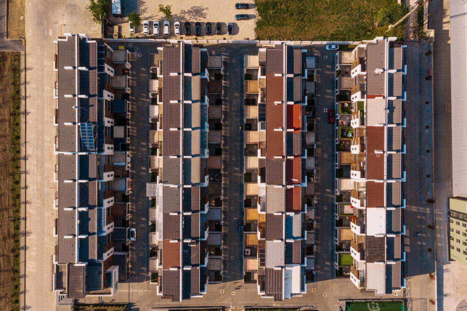 An aerial view of a row of apartment buildings in a residential area.