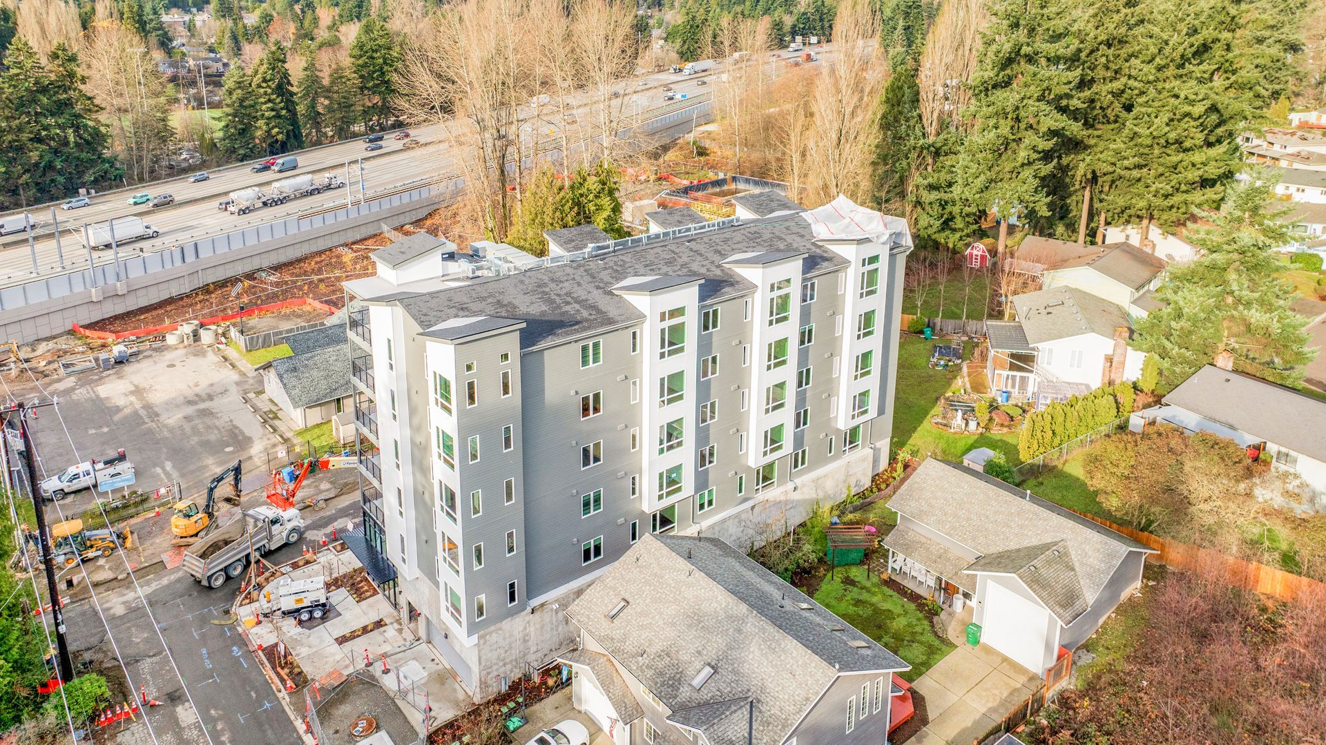An aerial view of a building under construction in a residential area.