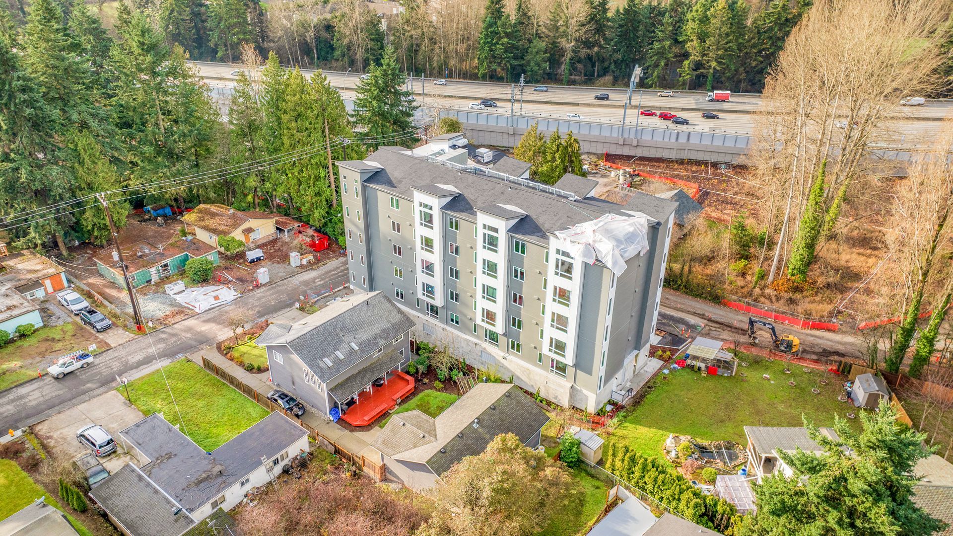 An aerial view of a building under construction in a residential area.