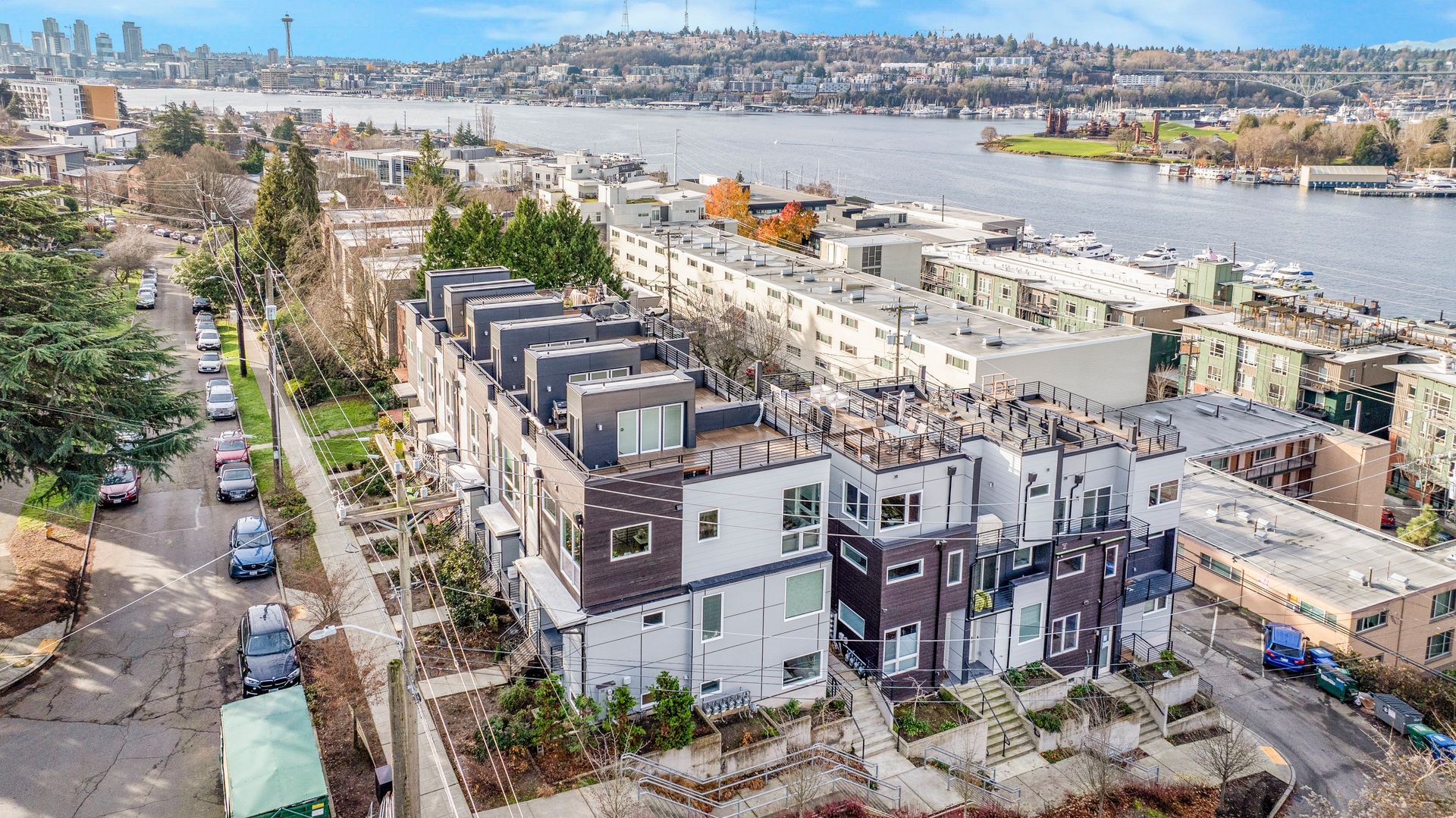 An aerial view of a city with a lot of buildings and a river in the background.