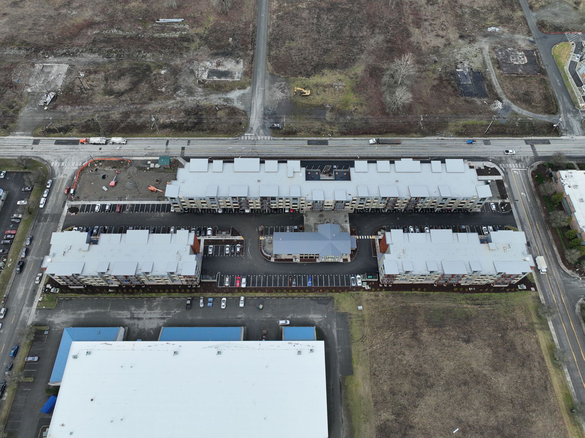 An aerial view of a large building with a white roof