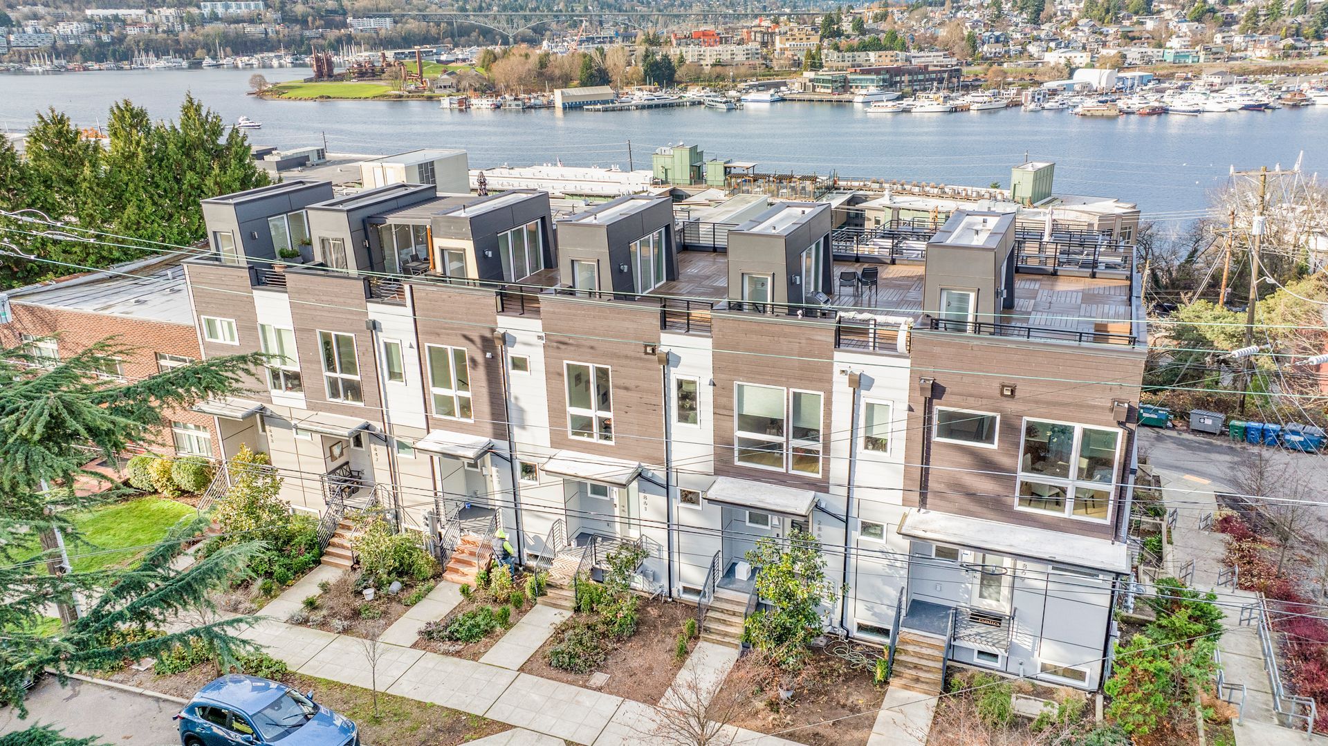 An aerial view of a row of houses next to a body of water.