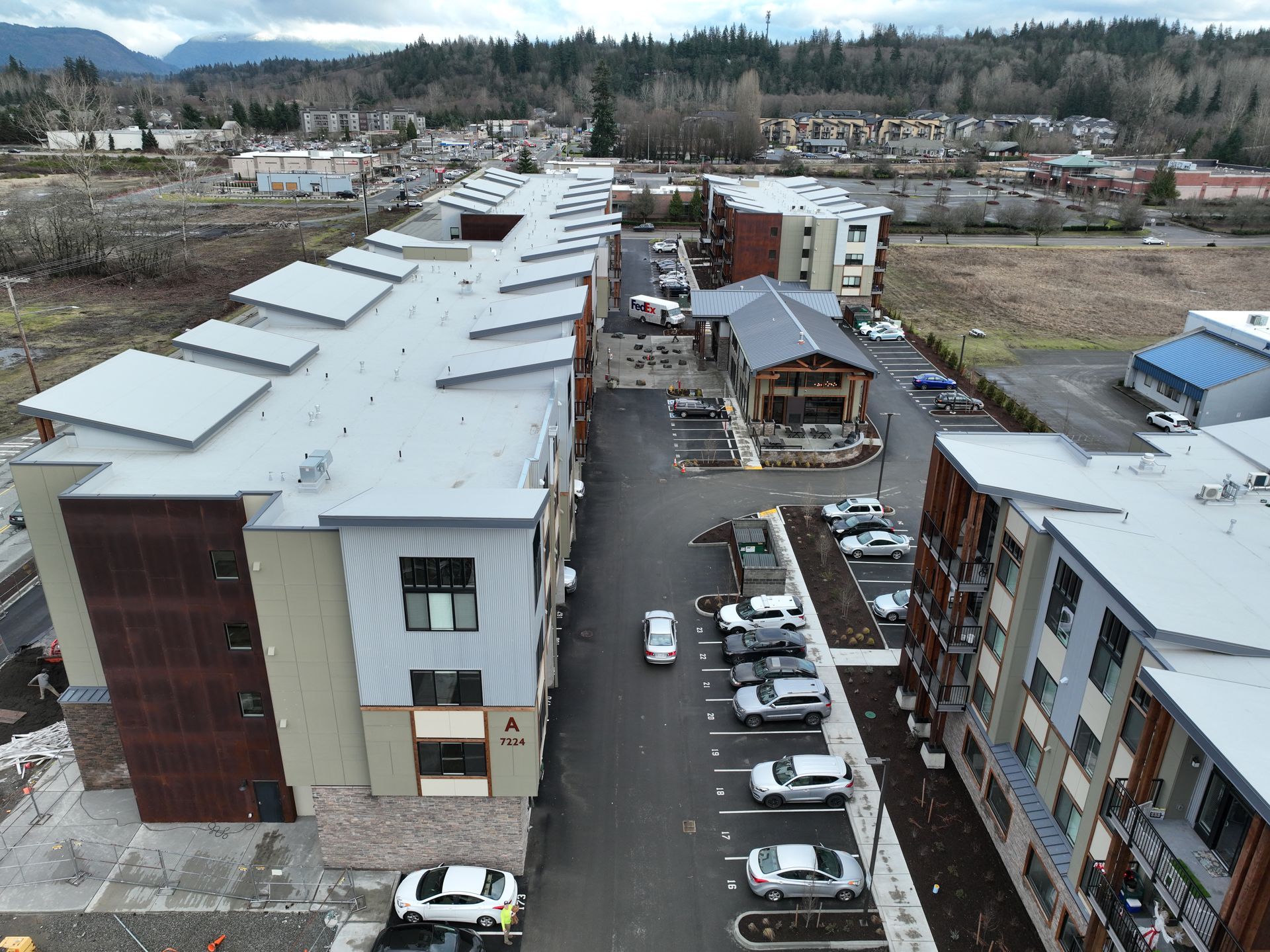 An aerial view of a building with a lot of cars parked in front of it