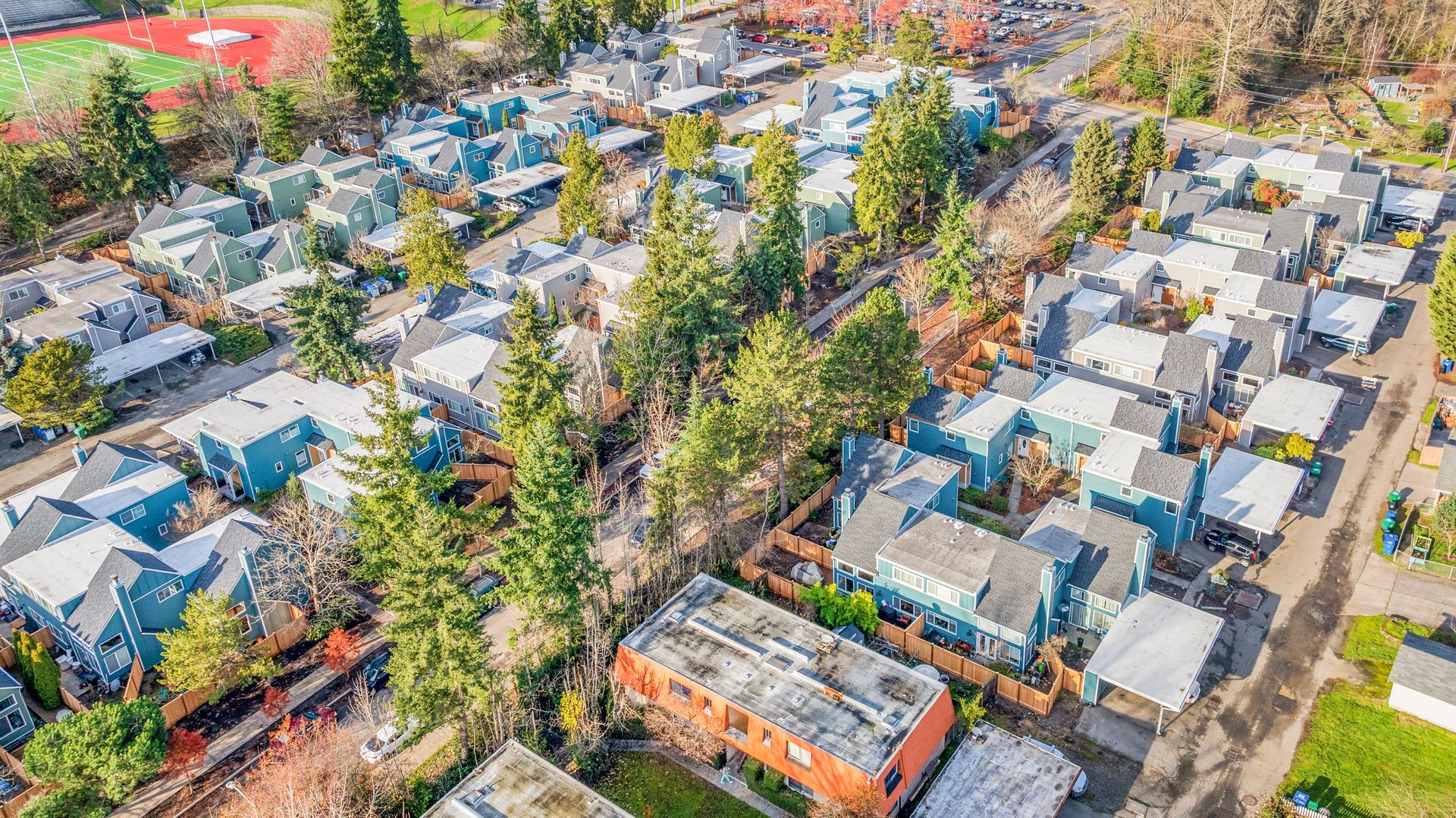 An aerial view of a residential area with lots of houses and trees.