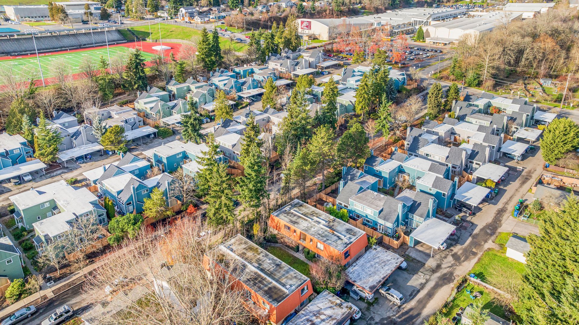 An aerial view of a residential area with lots of houses and trees.