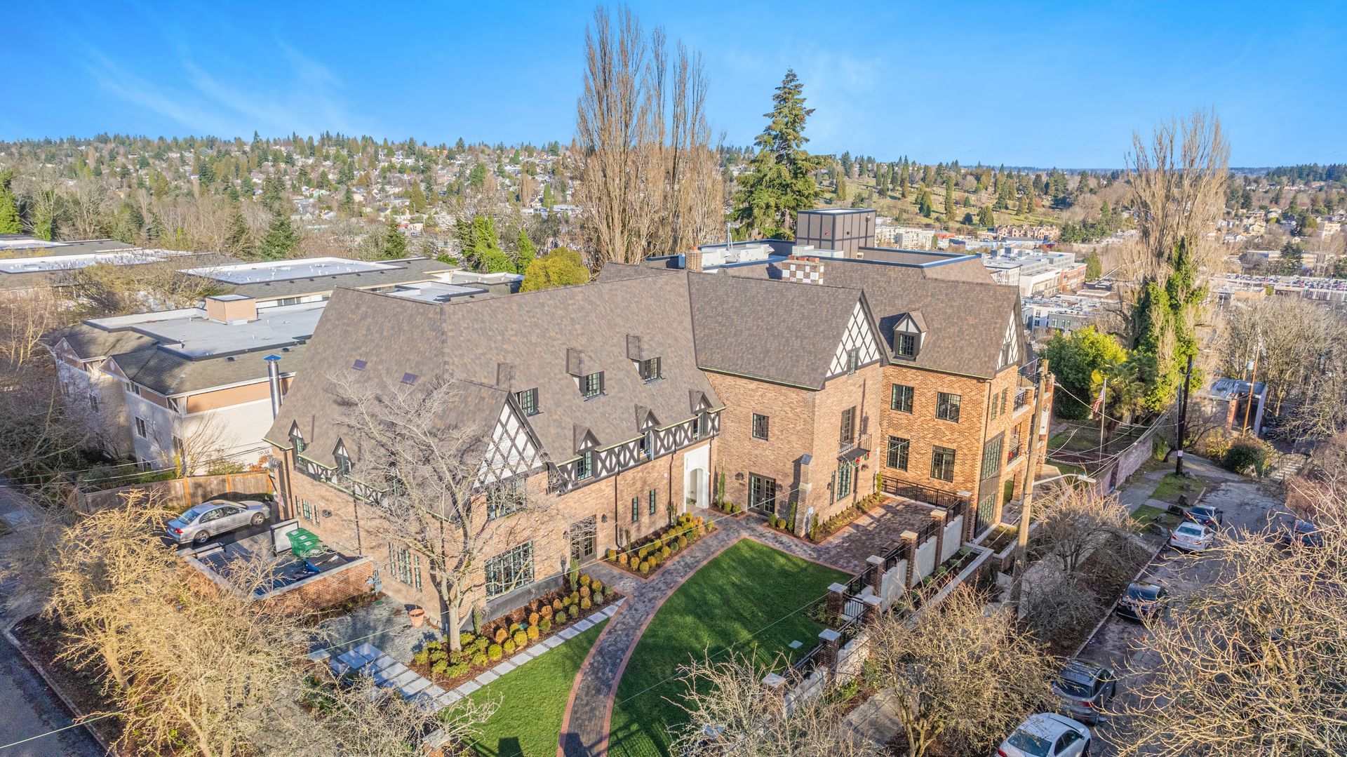 An aerial view of a large building with a large lawn in front of it.