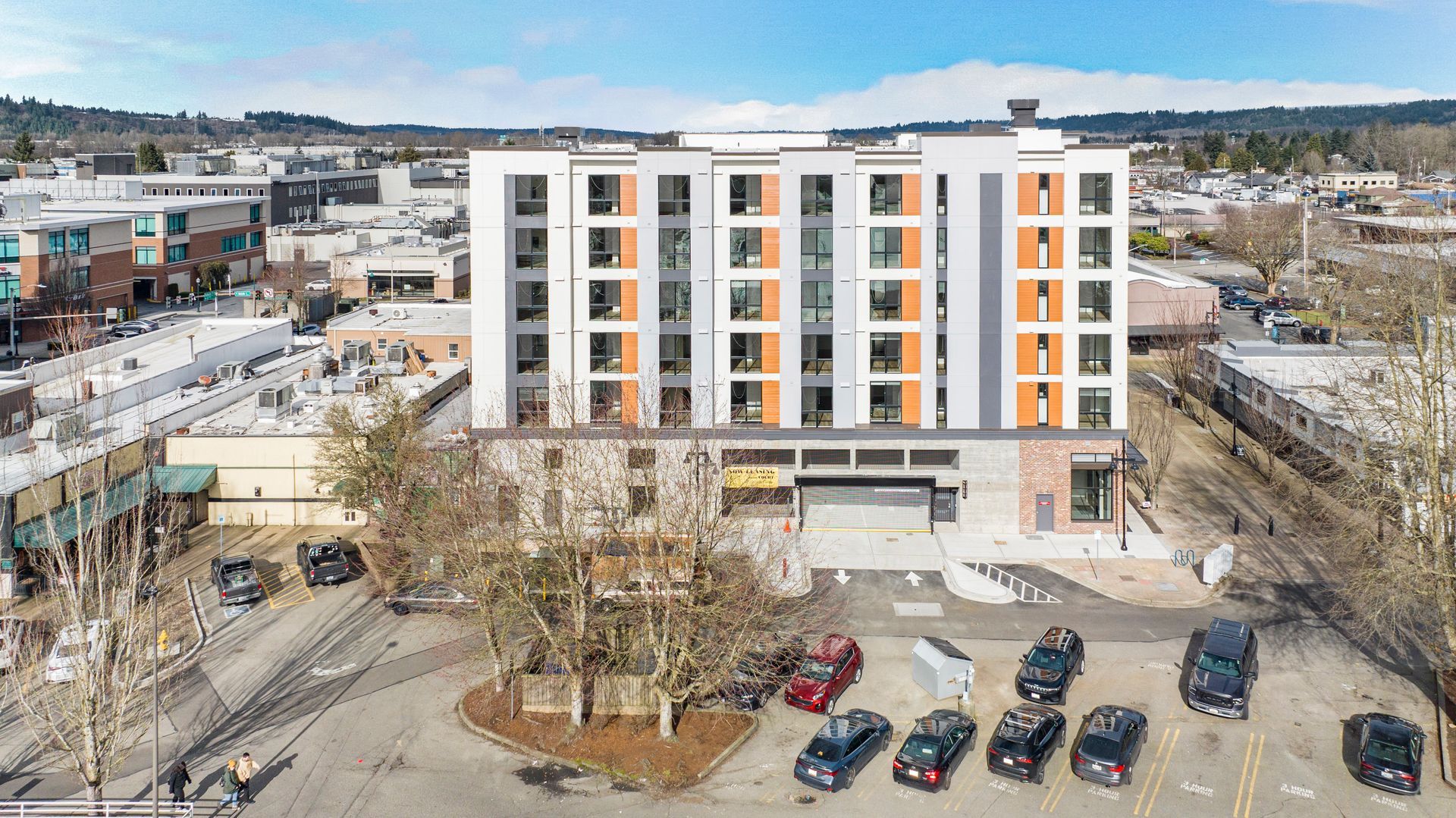 An aerial view of a building with cars parked in front of it.