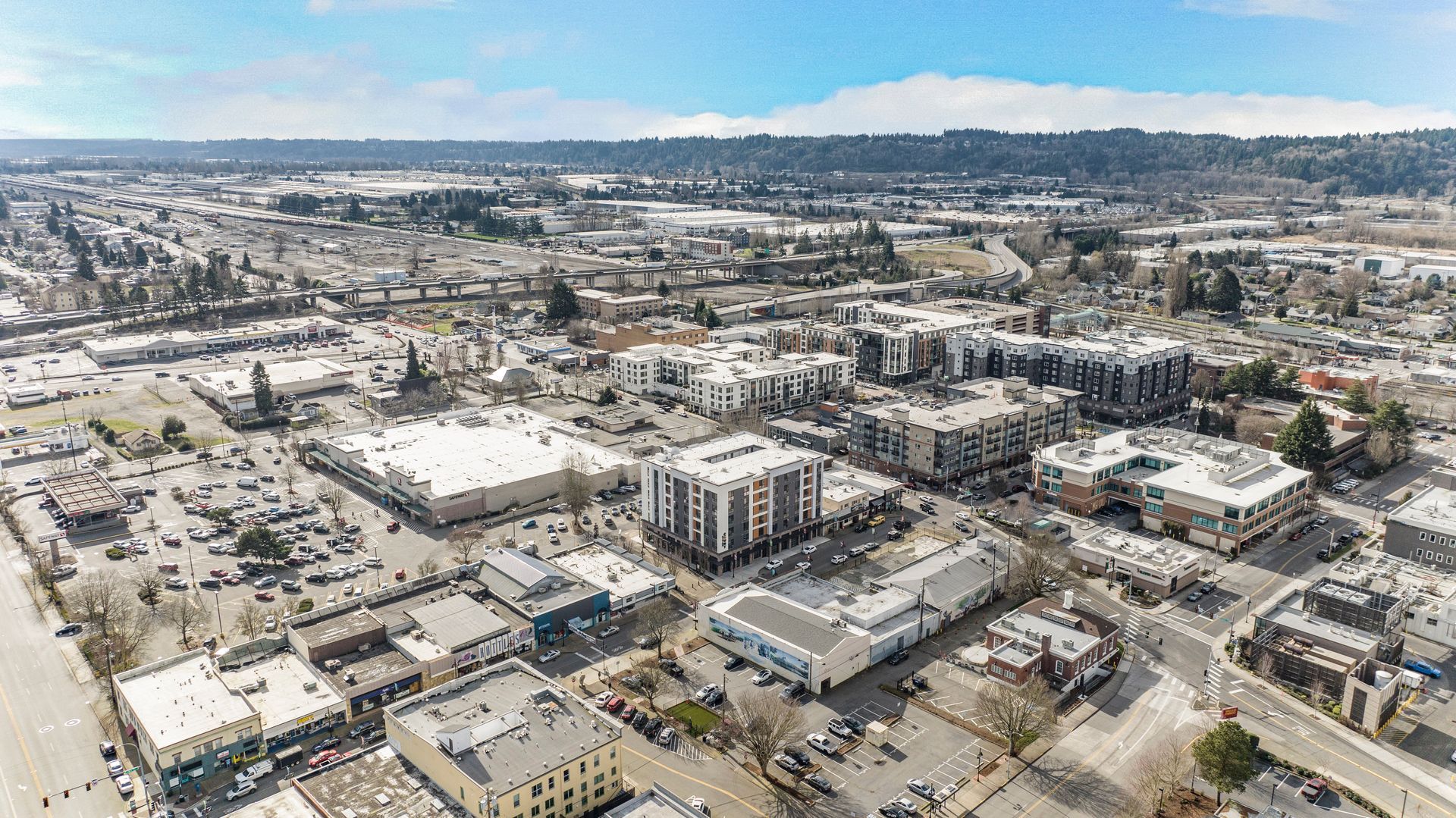 An aerial view of a city with lots of buildings and cars.