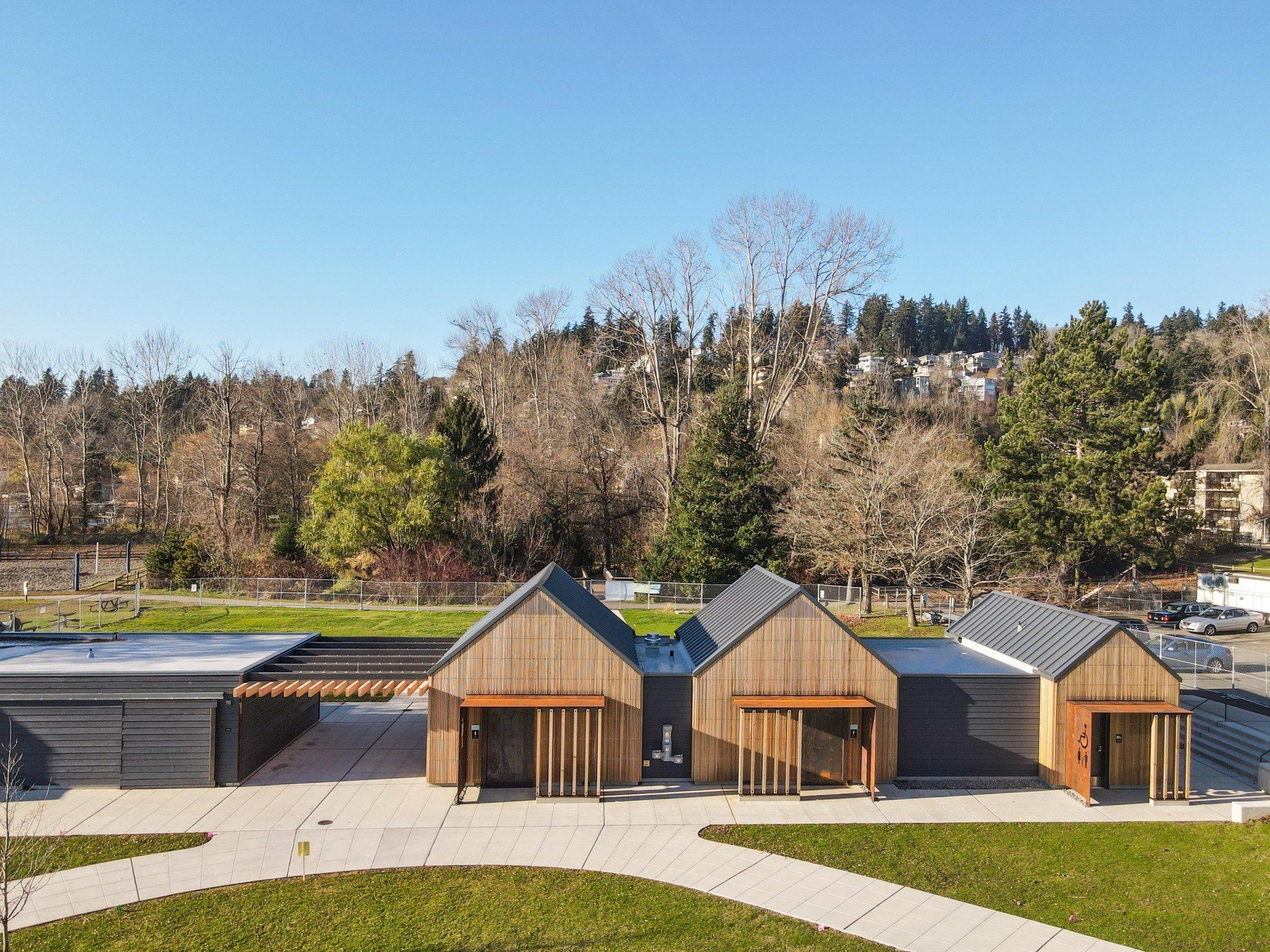 An aerial view of a row of wooden houses in a park.