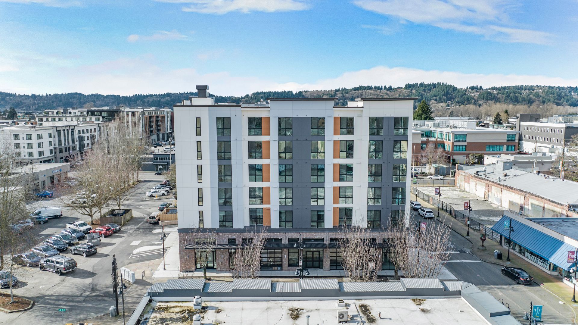 An aerial view of a large apartment building in a city.