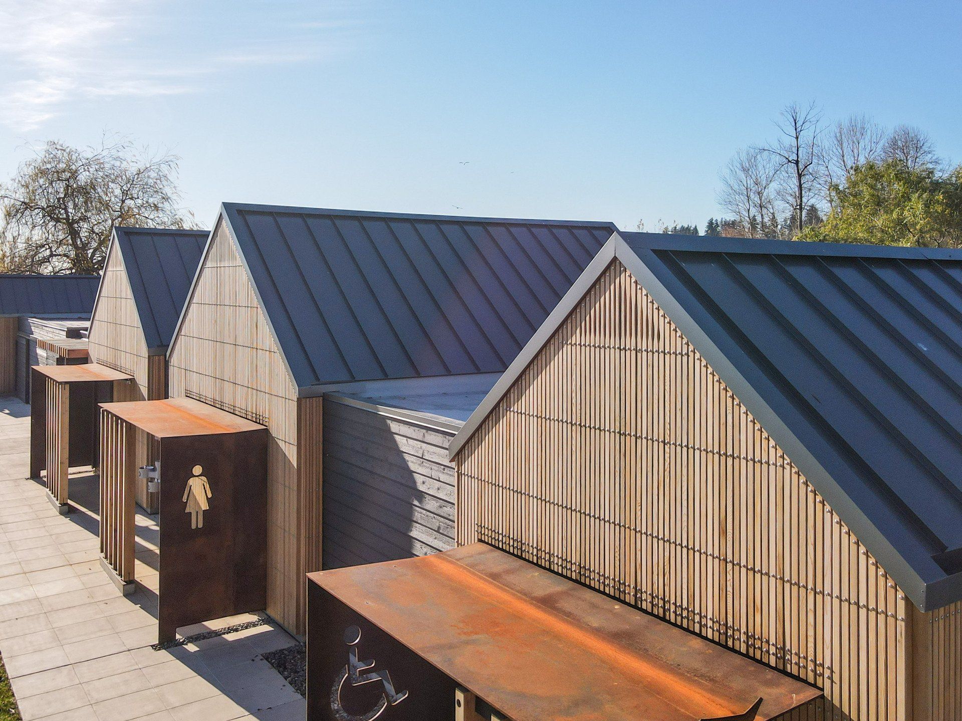 A row of wooden buildings with a black roof