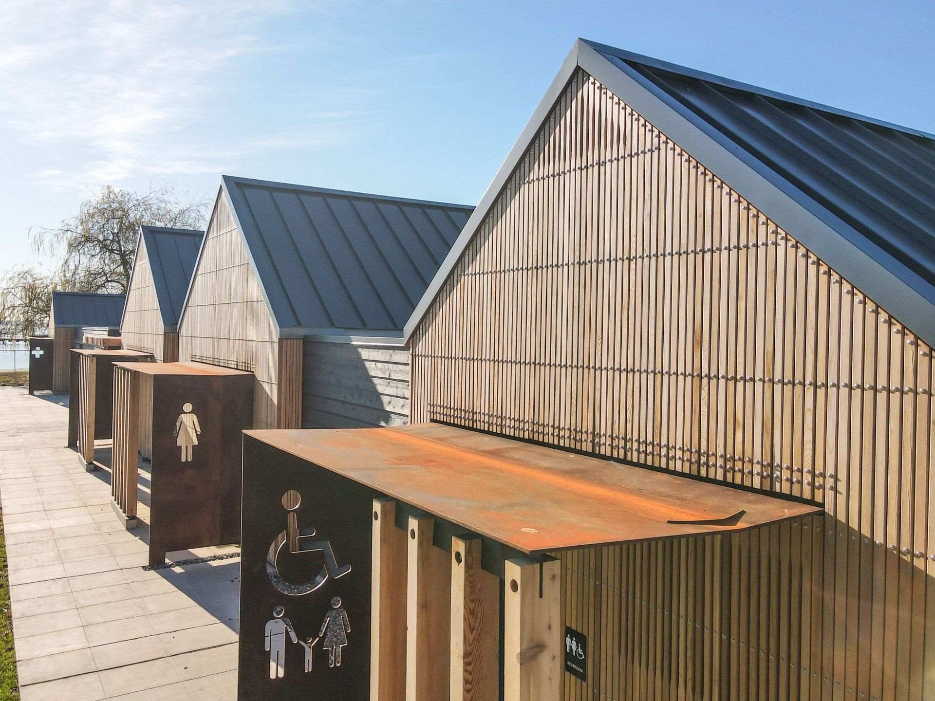 A row of wooden houses with a metal roof