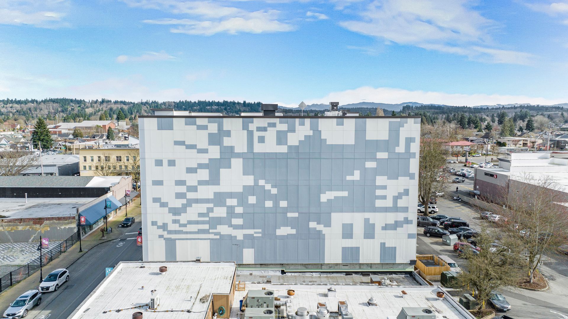 An aerial view of a building with a large mural on the side of it.