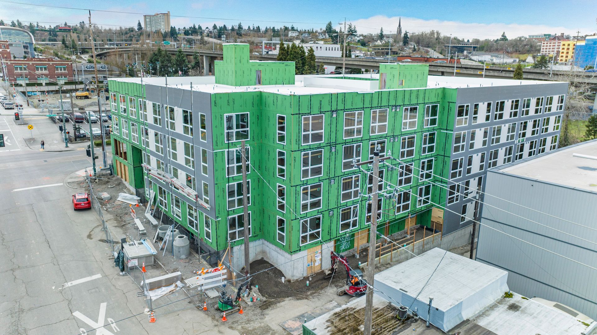 An aerial view of a building under construction in a city.