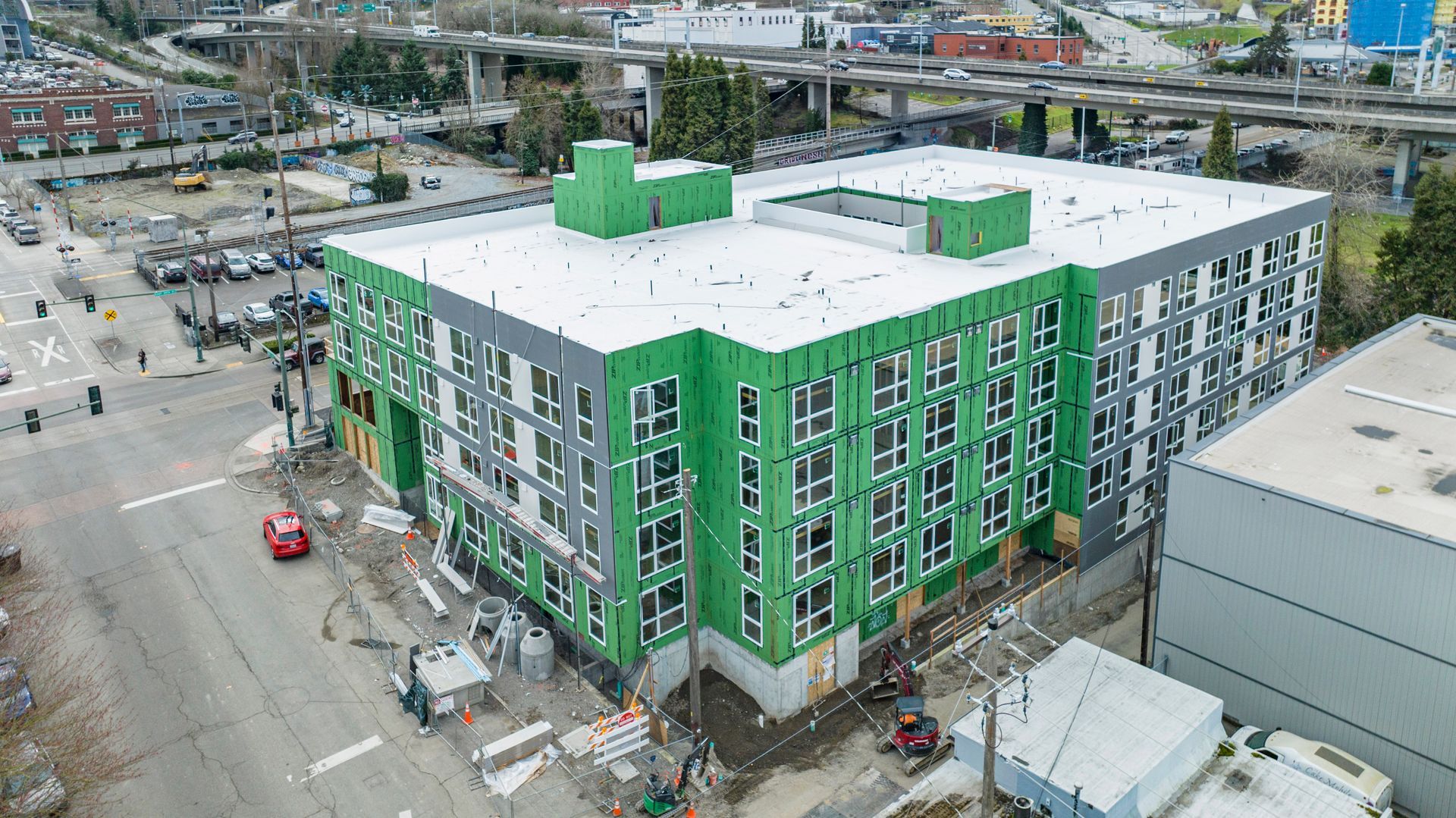 An aerial view of a building under construction in a city.