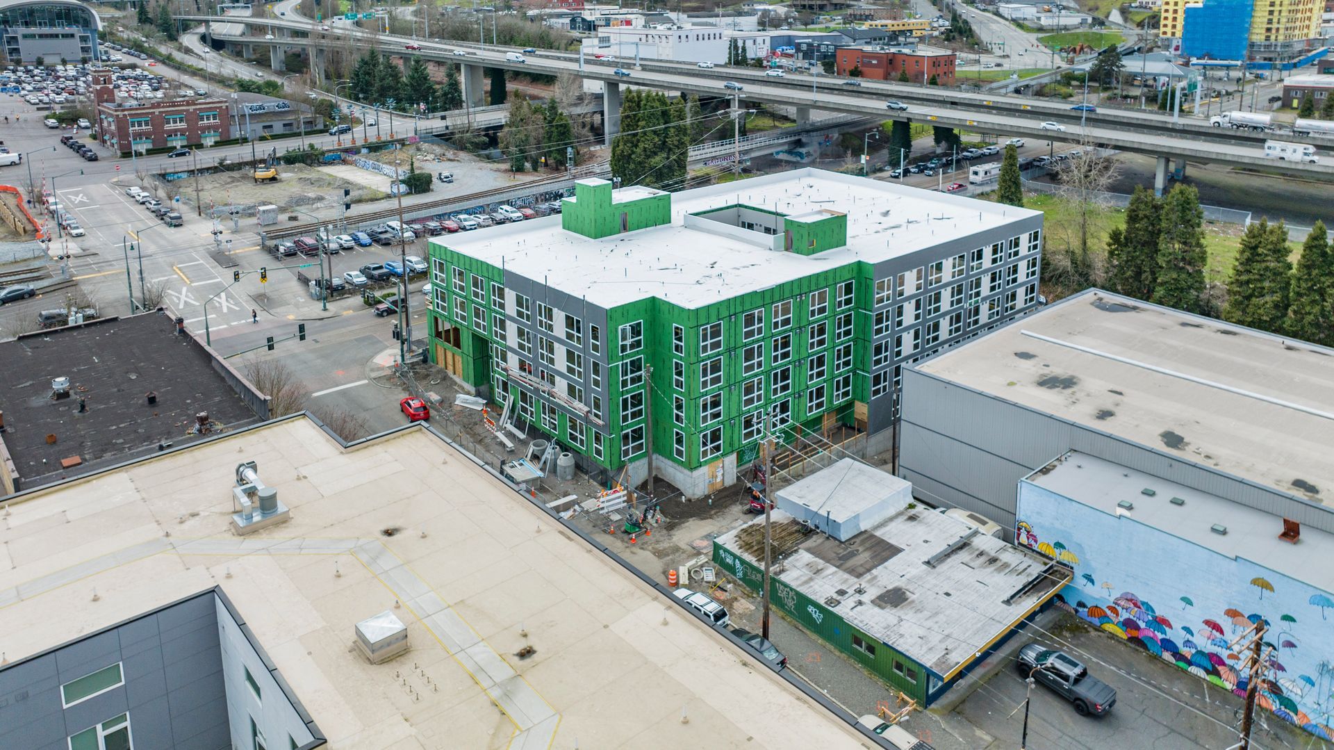 An aerial view of a building under construction in a city.