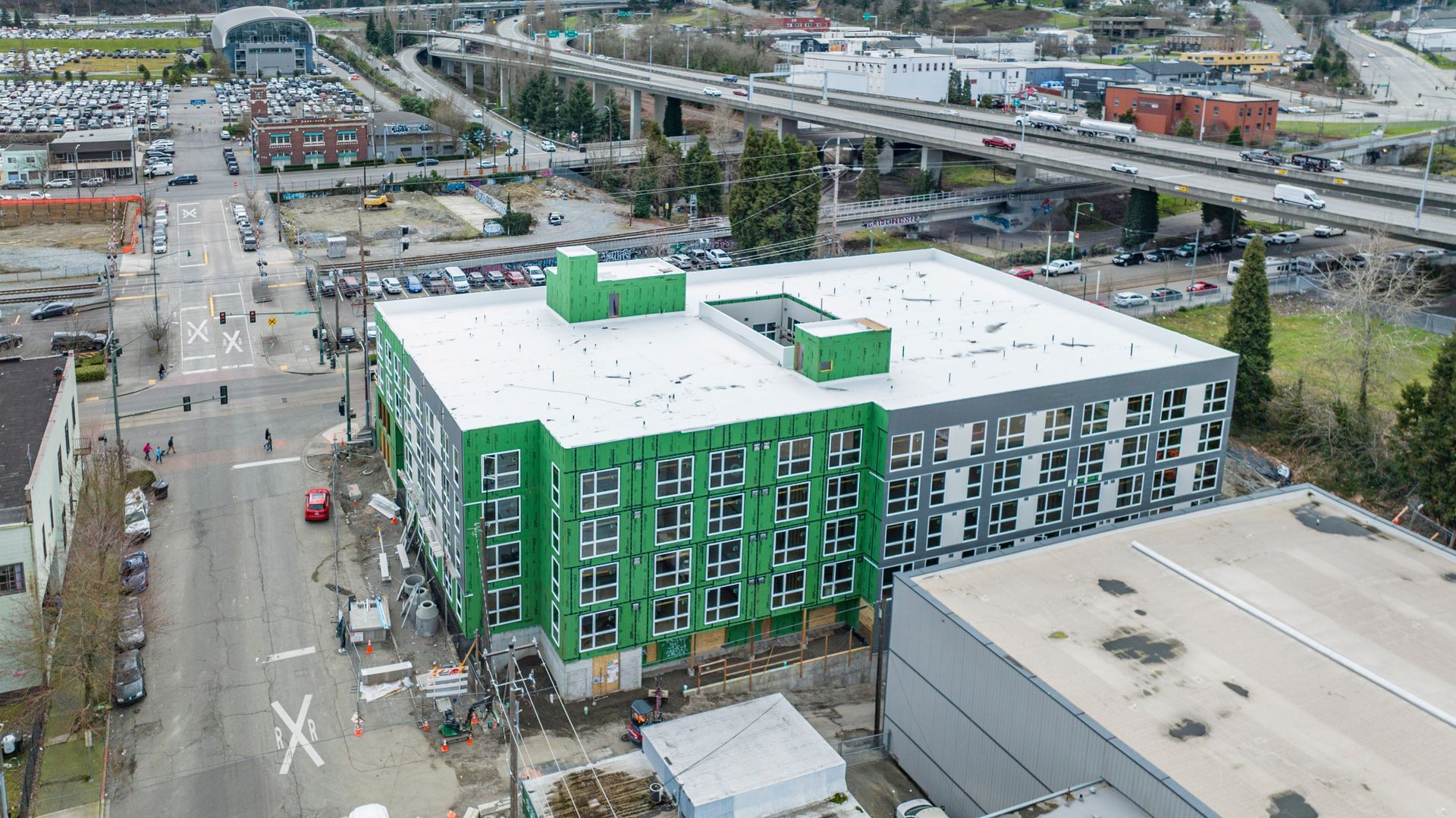 An aerial view of a building under construction in a city.