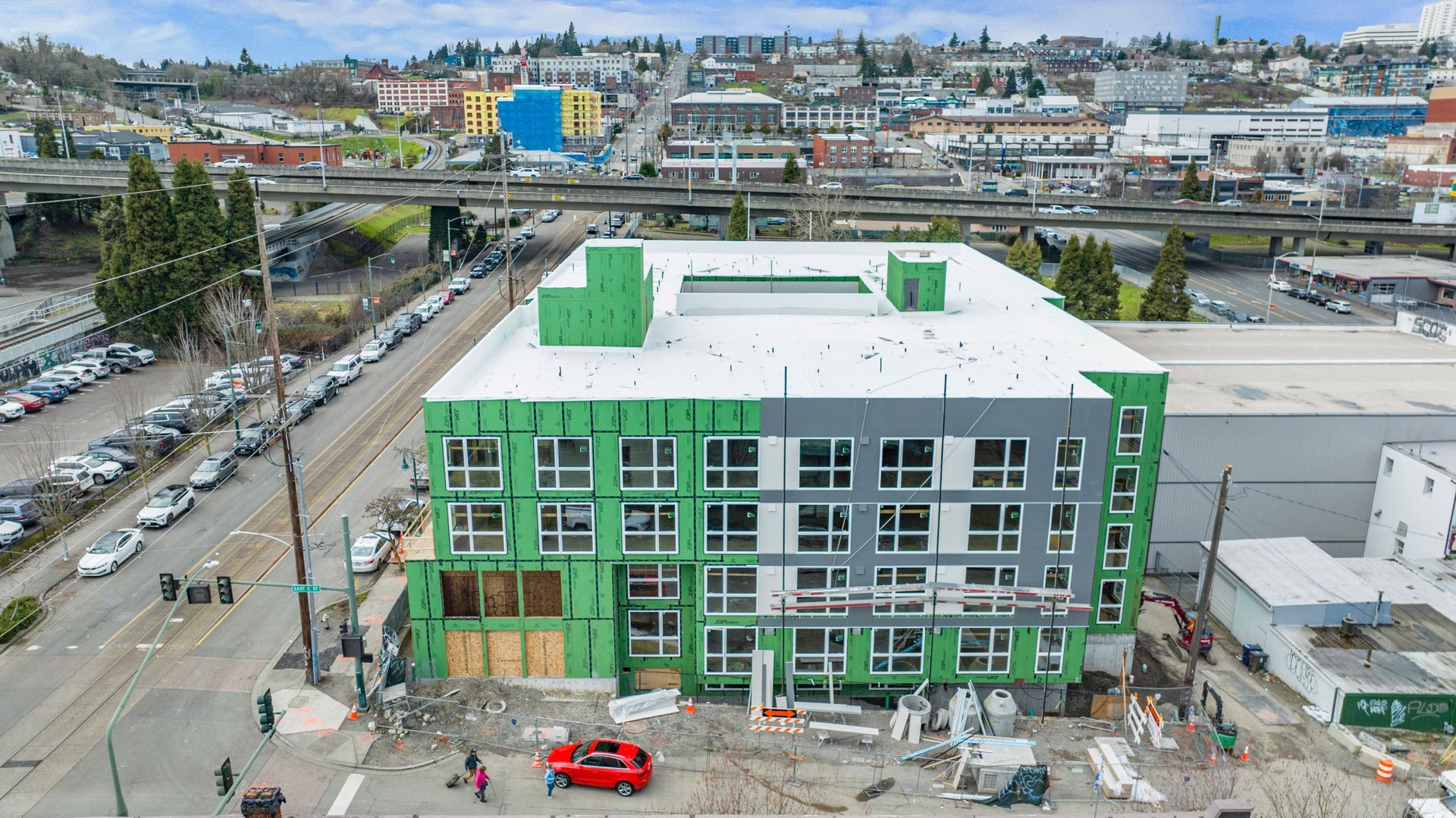 An aerial view of a building under construction in a city.