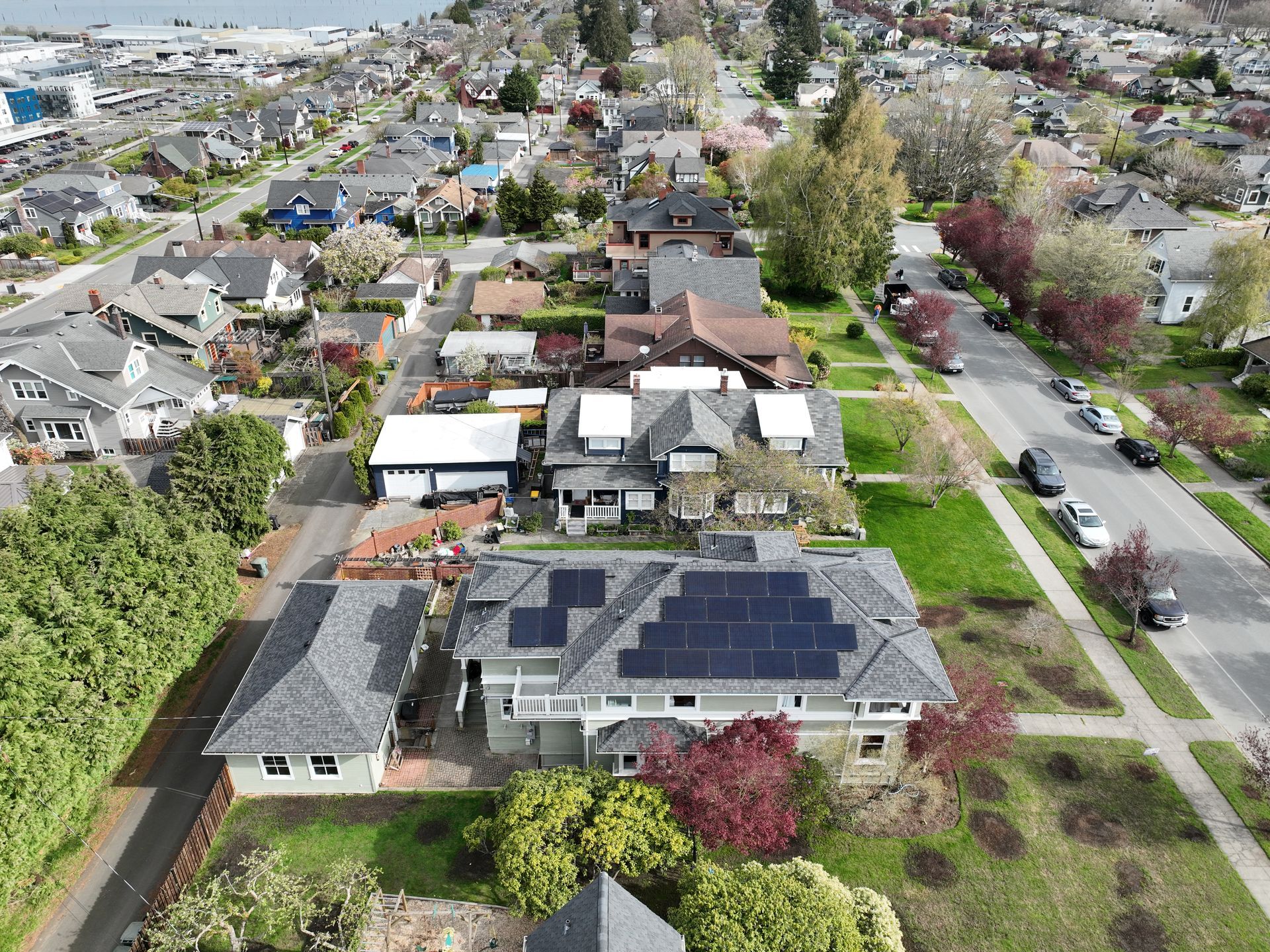 An aerial view of a house with solar panels on the roof.