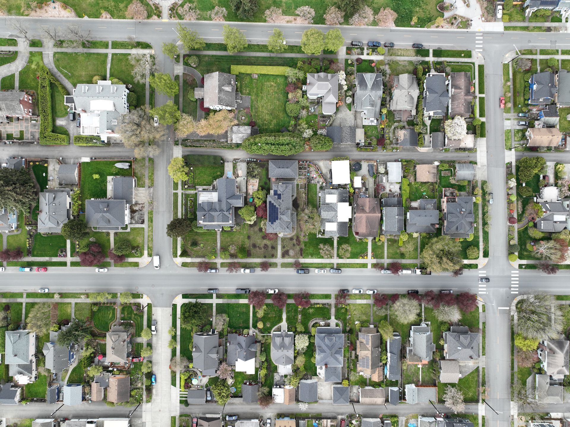 An aerial view of a residential neighborhood with lots of houses and trees.