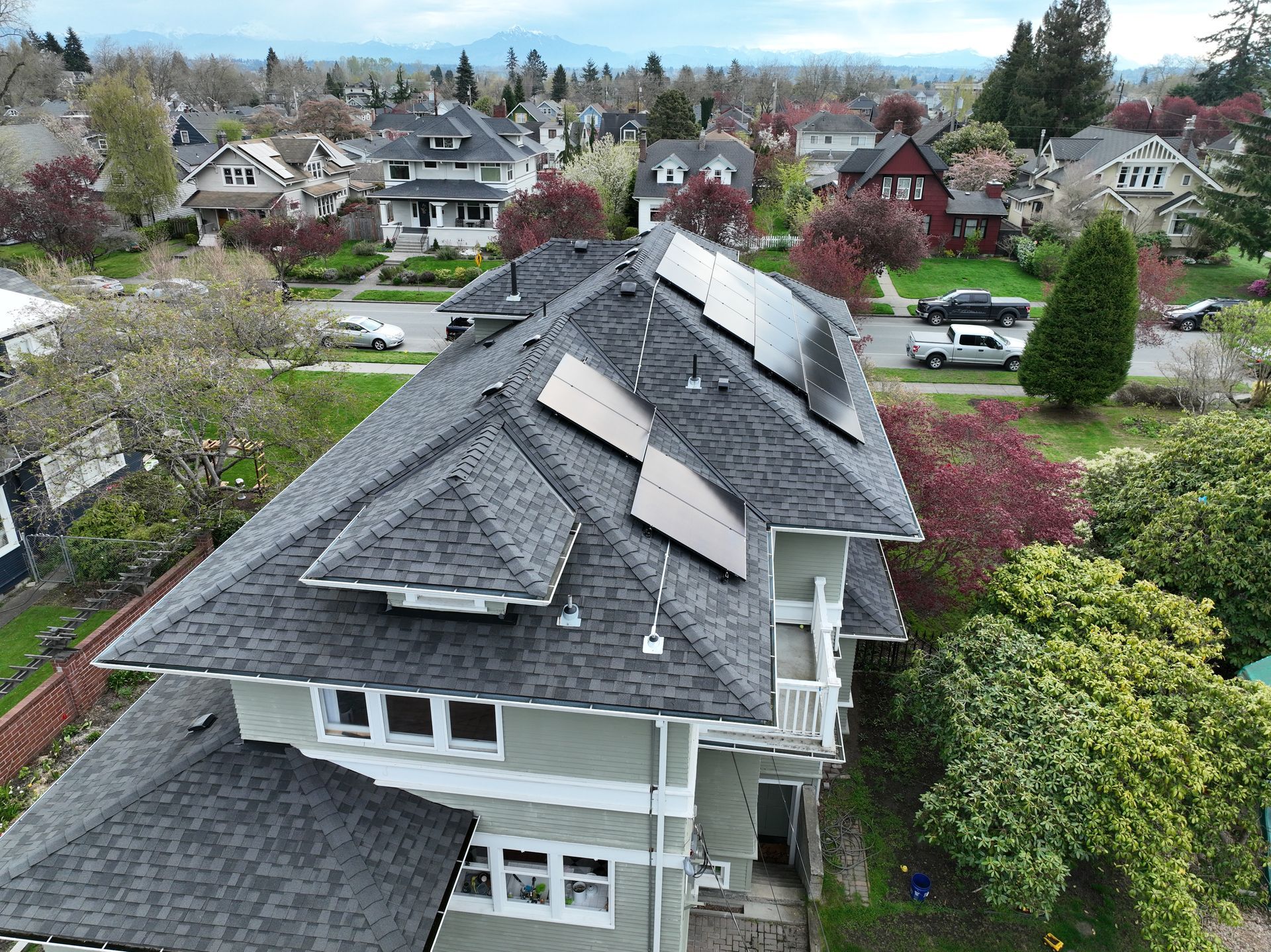 An aerial view of a house with solar panels on the roof.