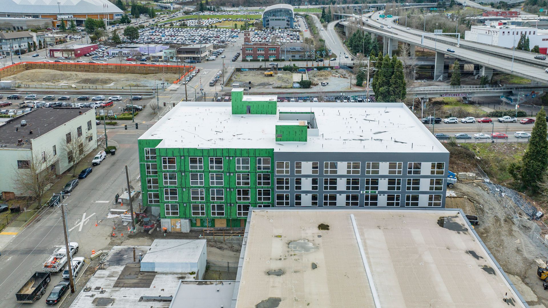 An aerial view of a building under construction in a city.