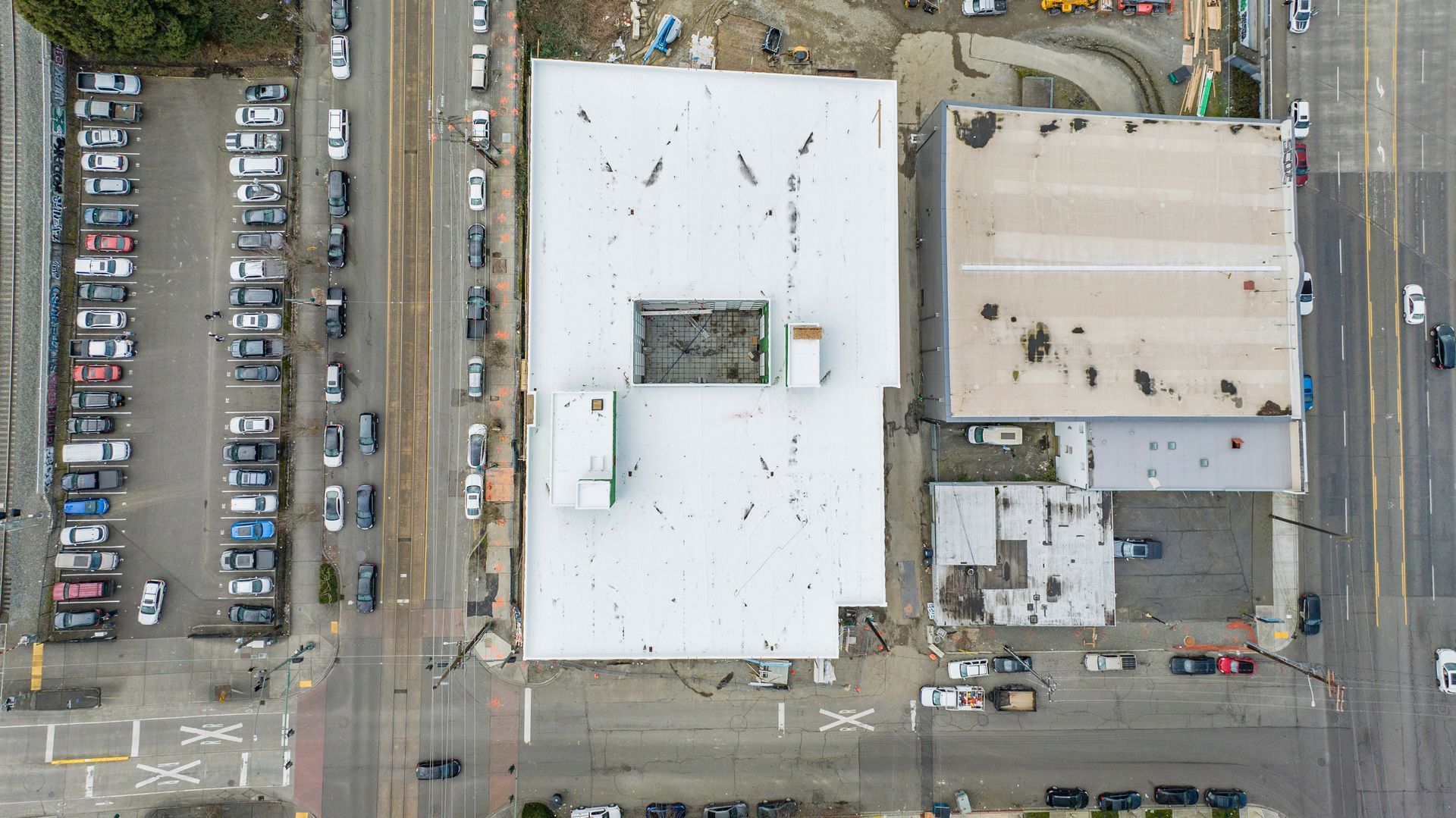 An aerial view of a building with a white roof