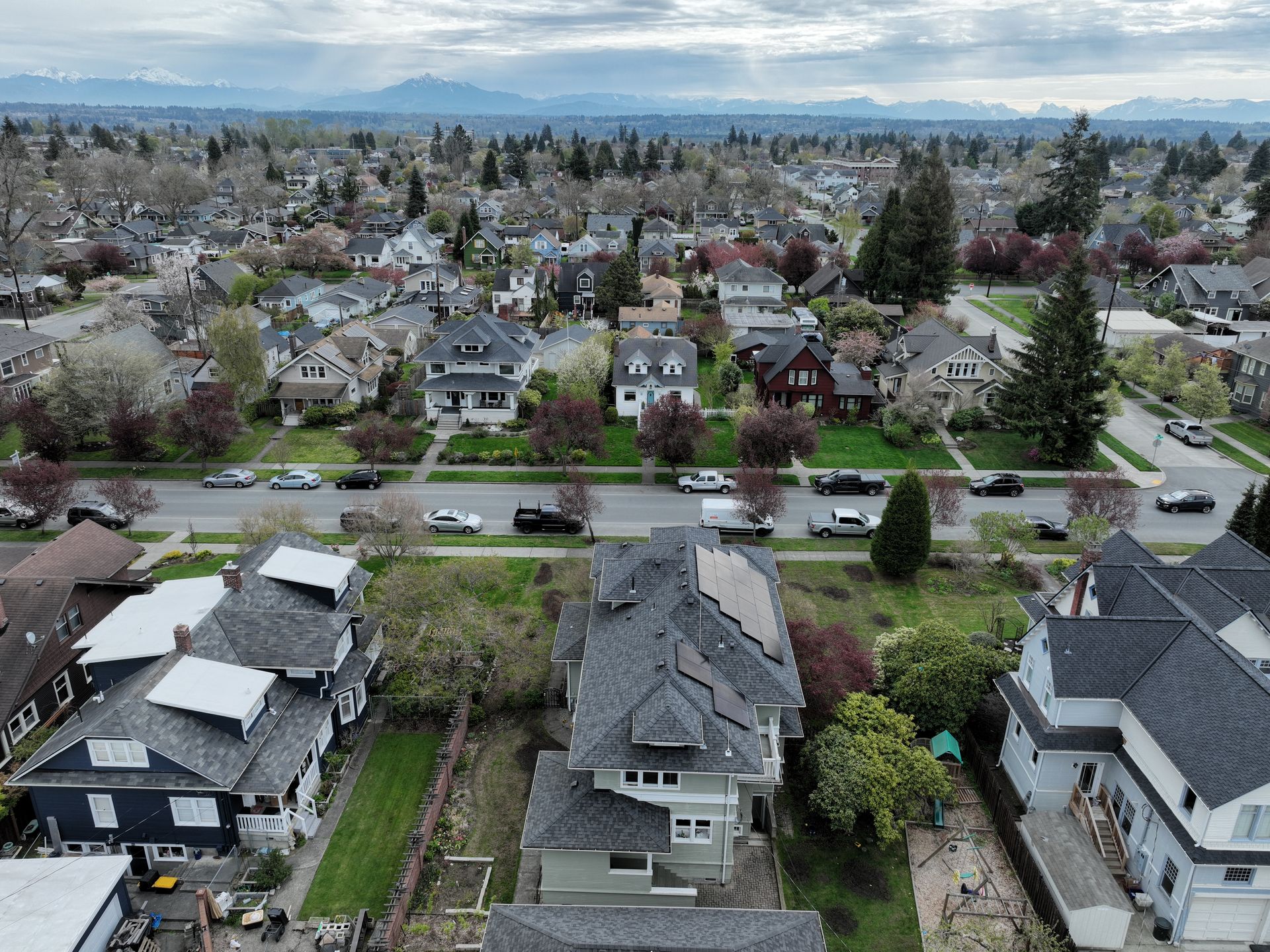 An aerial view of a residential area with a lot of houses and trees.