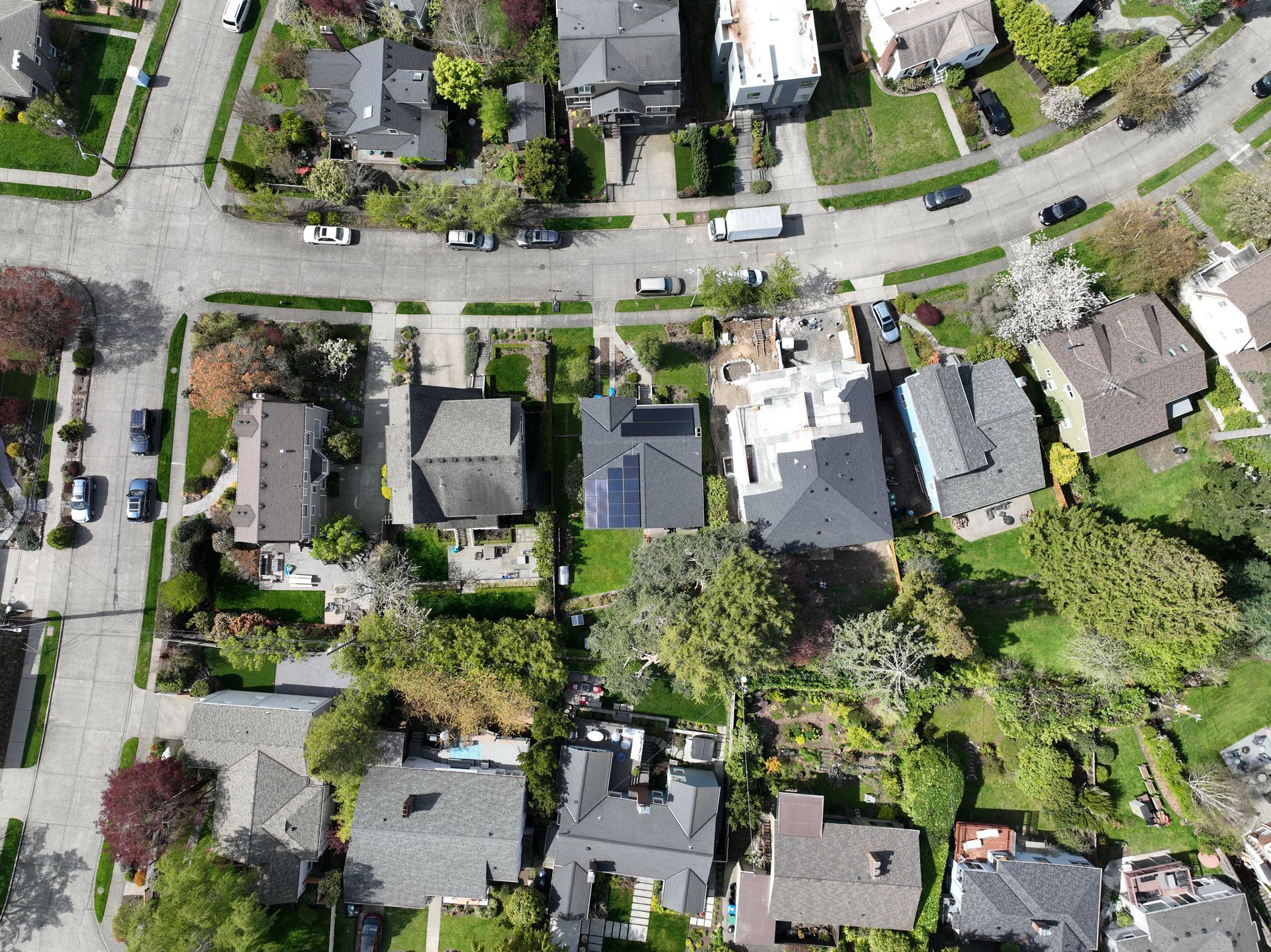 An aerial view of a residential neighborhood with lots of houses and trees.