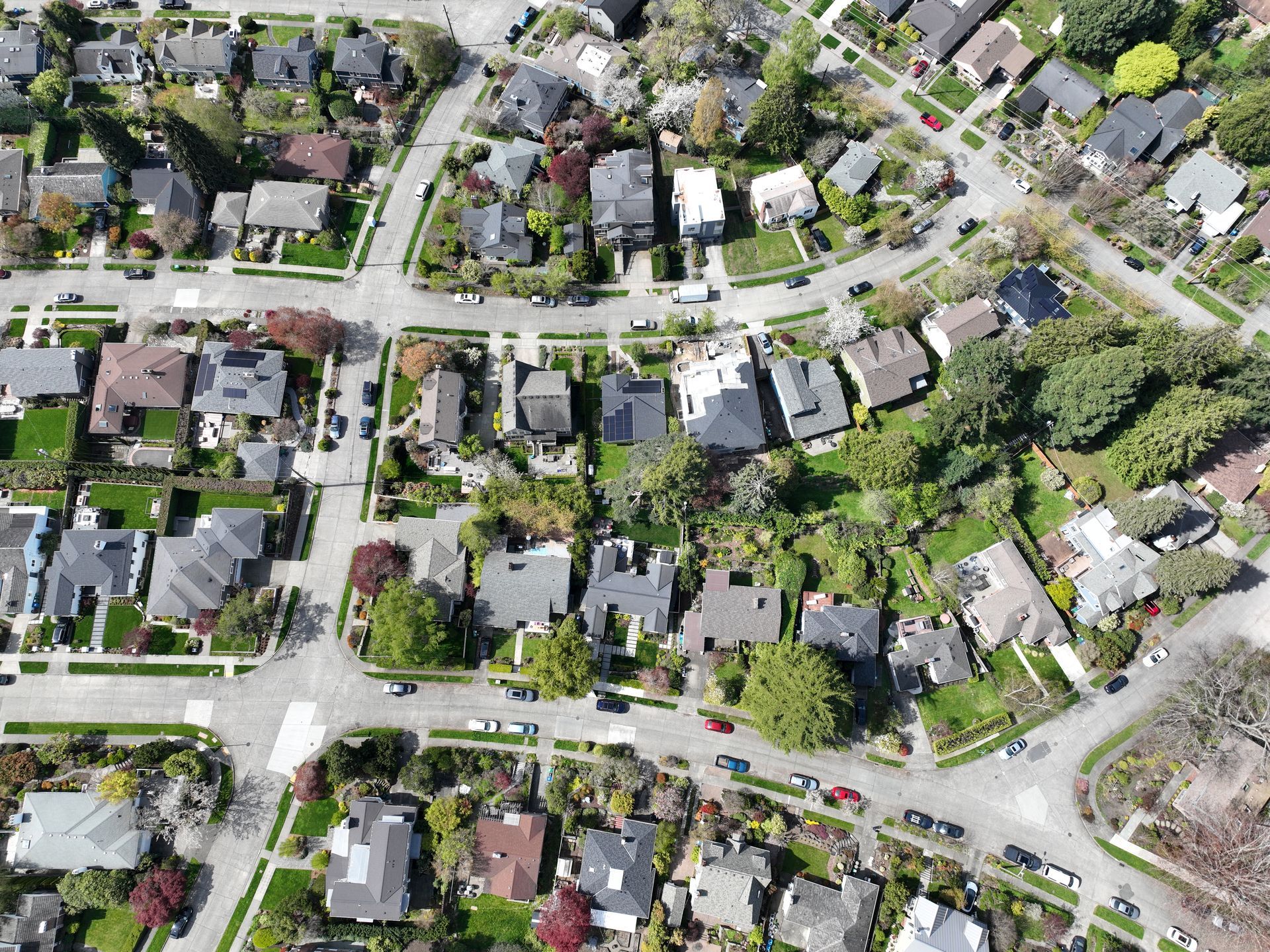 An aerial view of a residential neighborhood with lots of houses and trees.