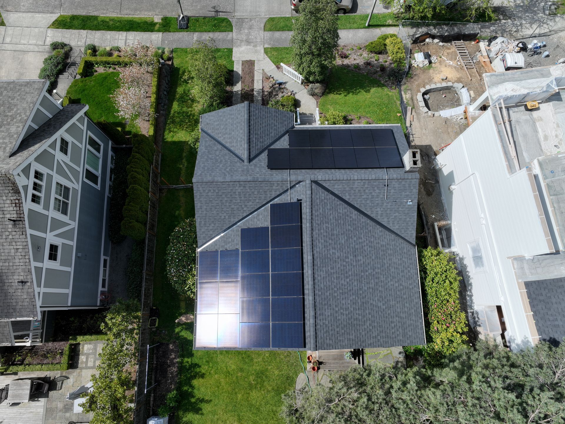 An aerial view of a house with solar panels on the roof.